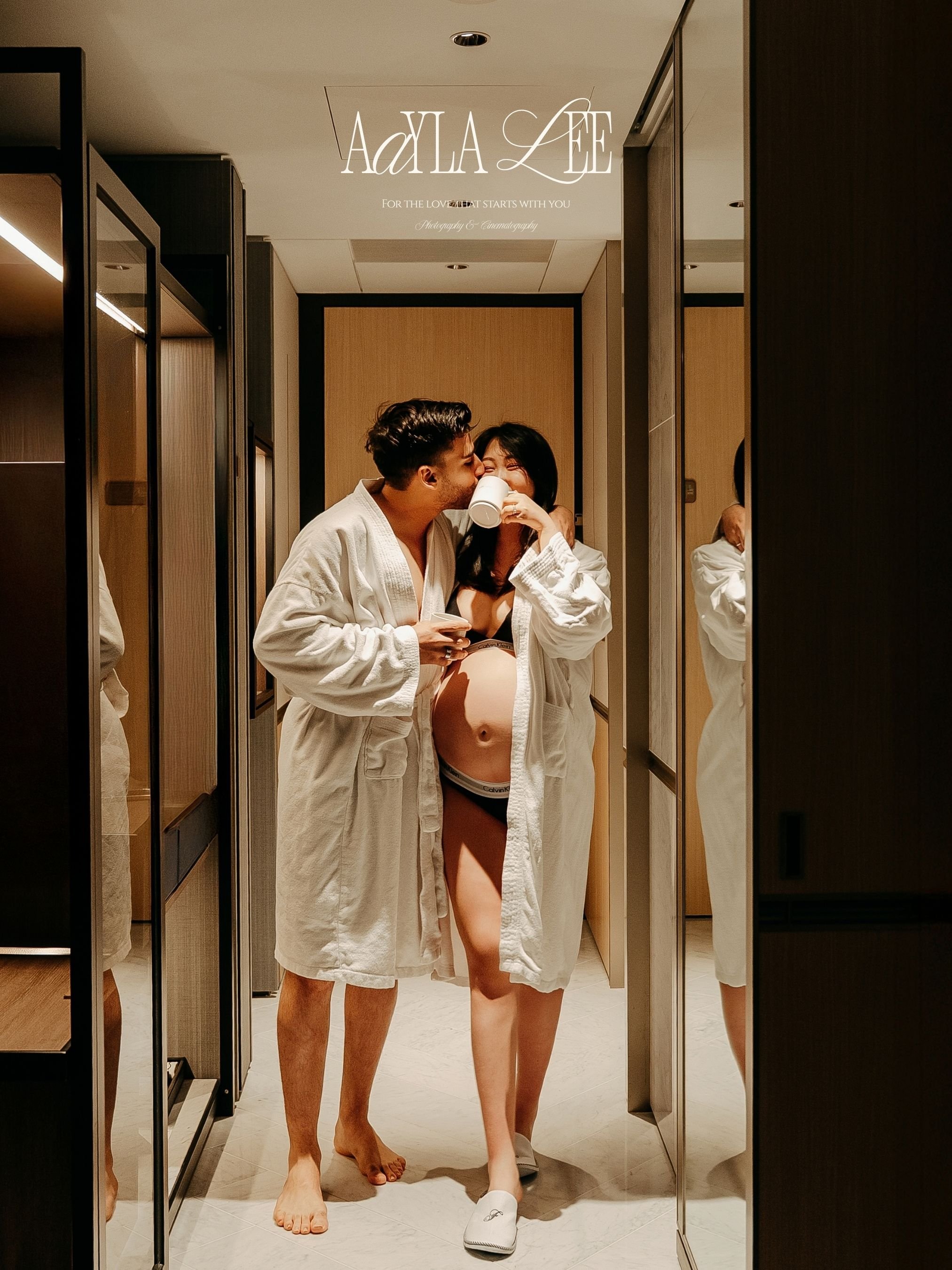 Maternity portrait in white robe reading in hotel bed, Fairmont Seoul