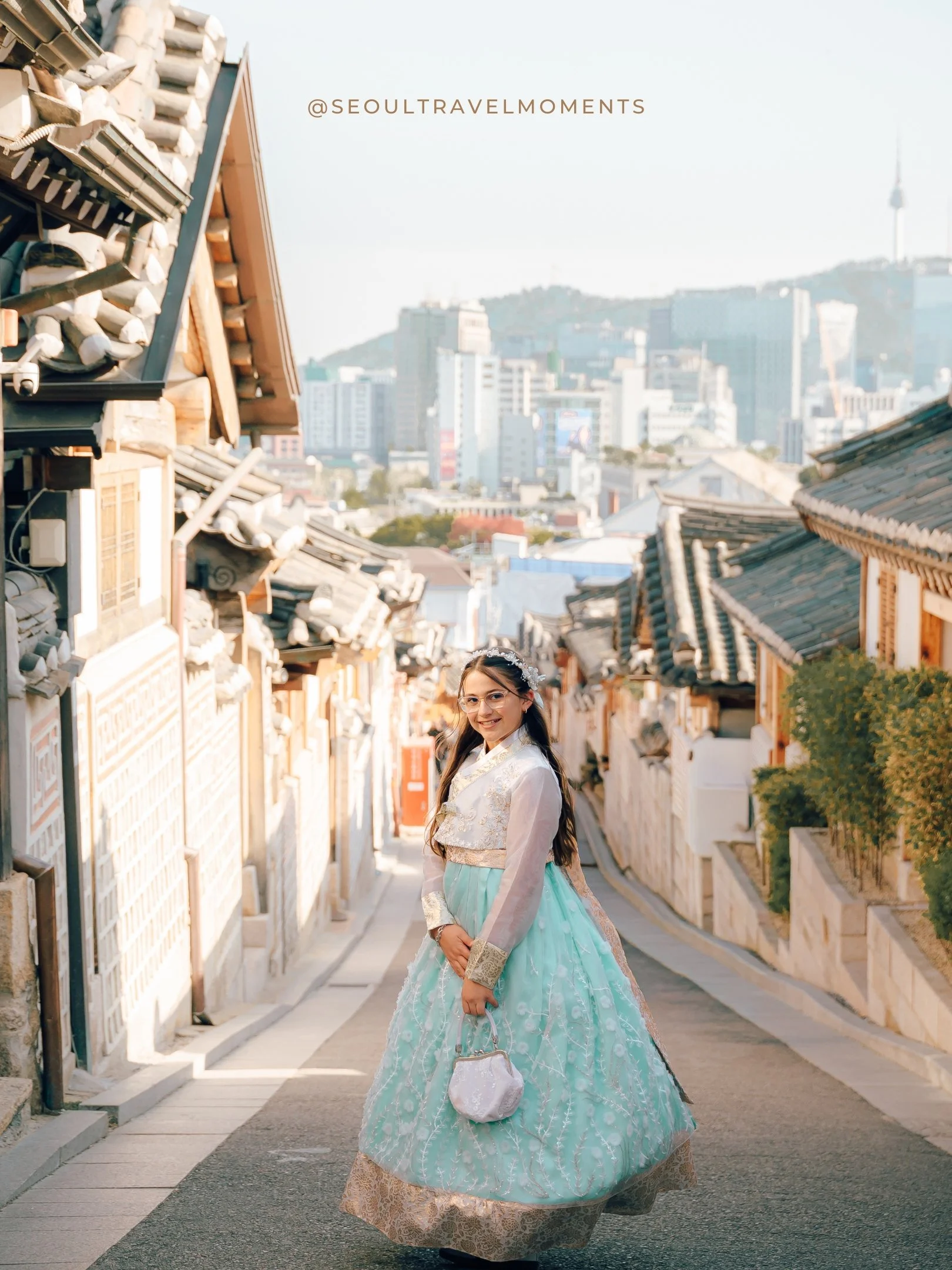 Mother and daughters enjoying a fun and active family session in Seoul wearing hanbok