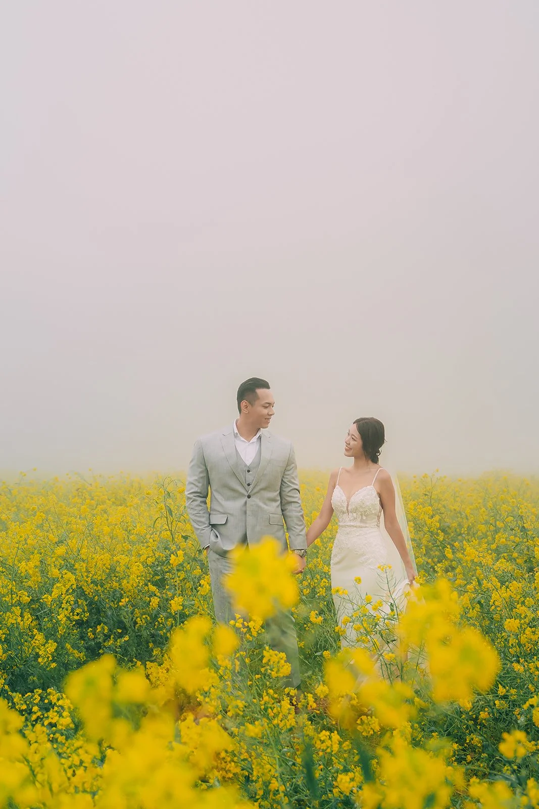 Behind-the-scenes photograph of Seoul-based lifestyle photographer Ayla Lee working in canola fields on Jeju Island Korea