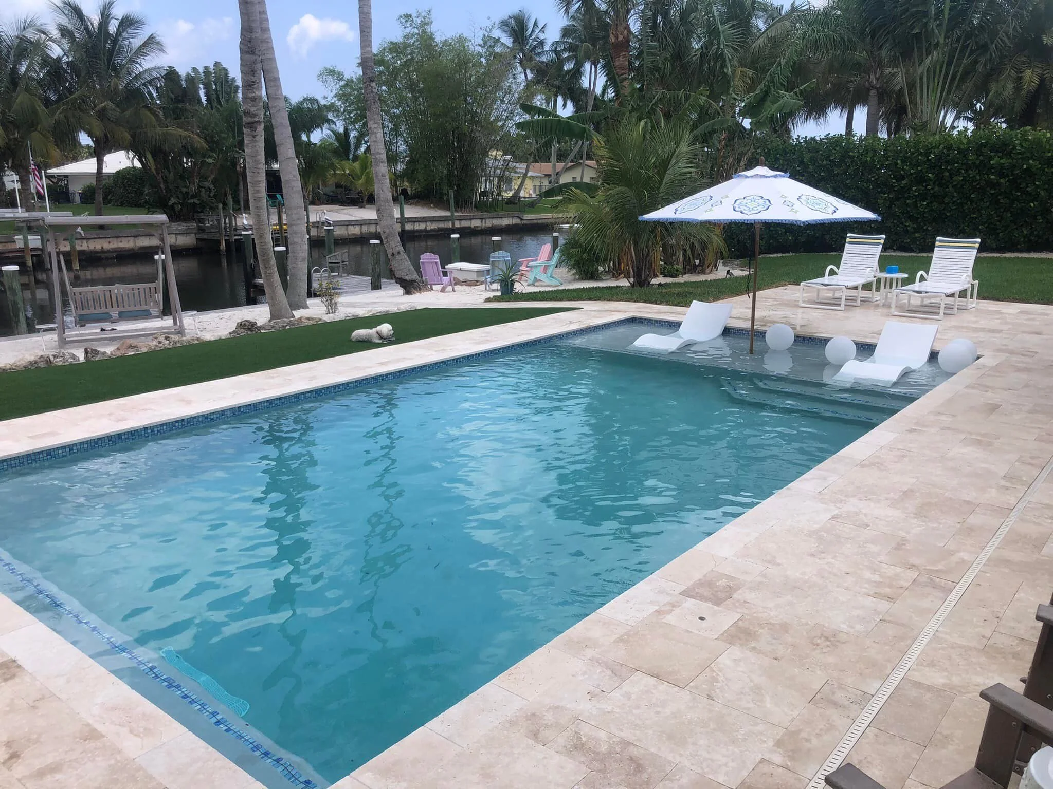 rectilinear pool with sunshelf and stone deck.jpg