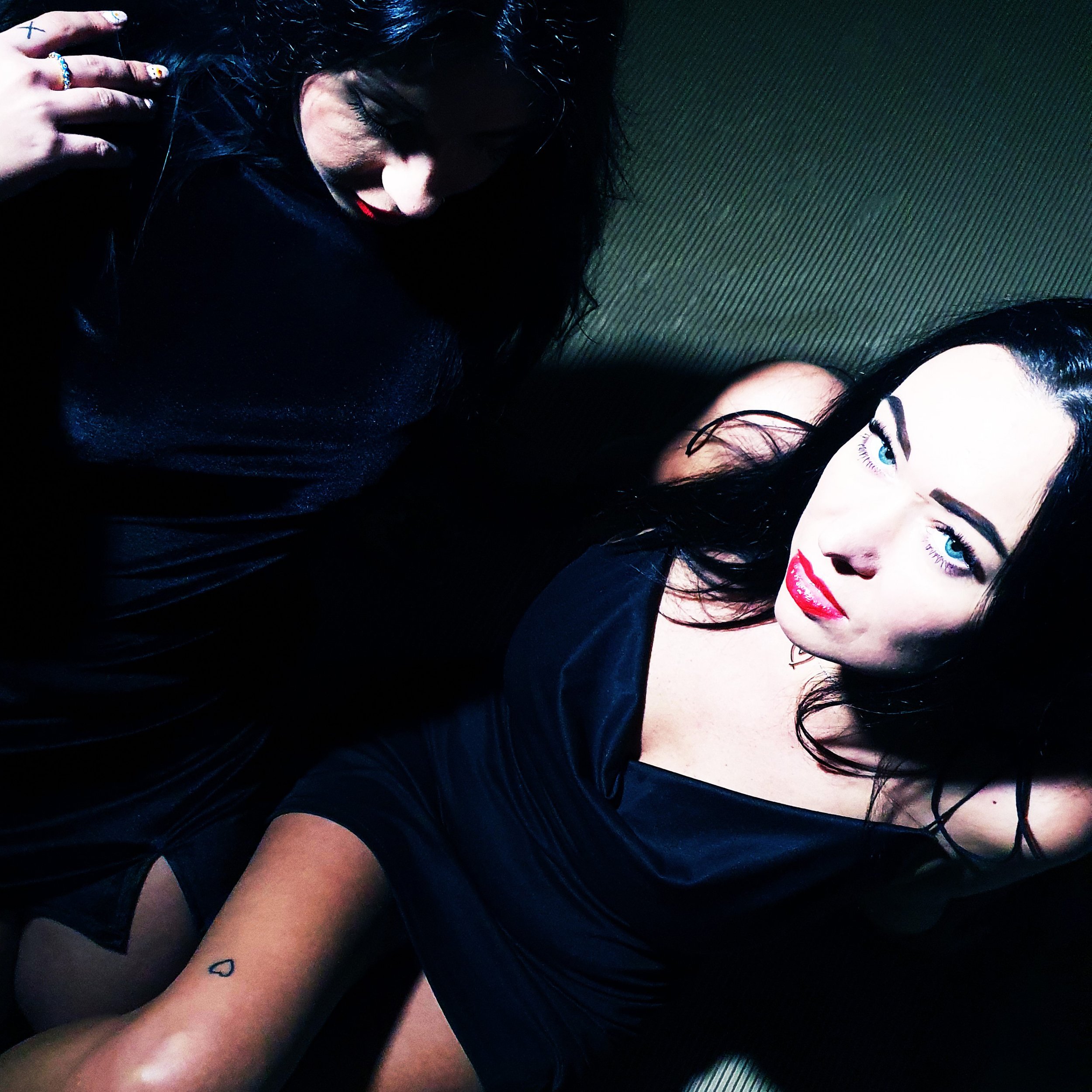 Two women in black dresses photographed from above, from the Fever — Deconstructed Beauty project by Krys Kona.
