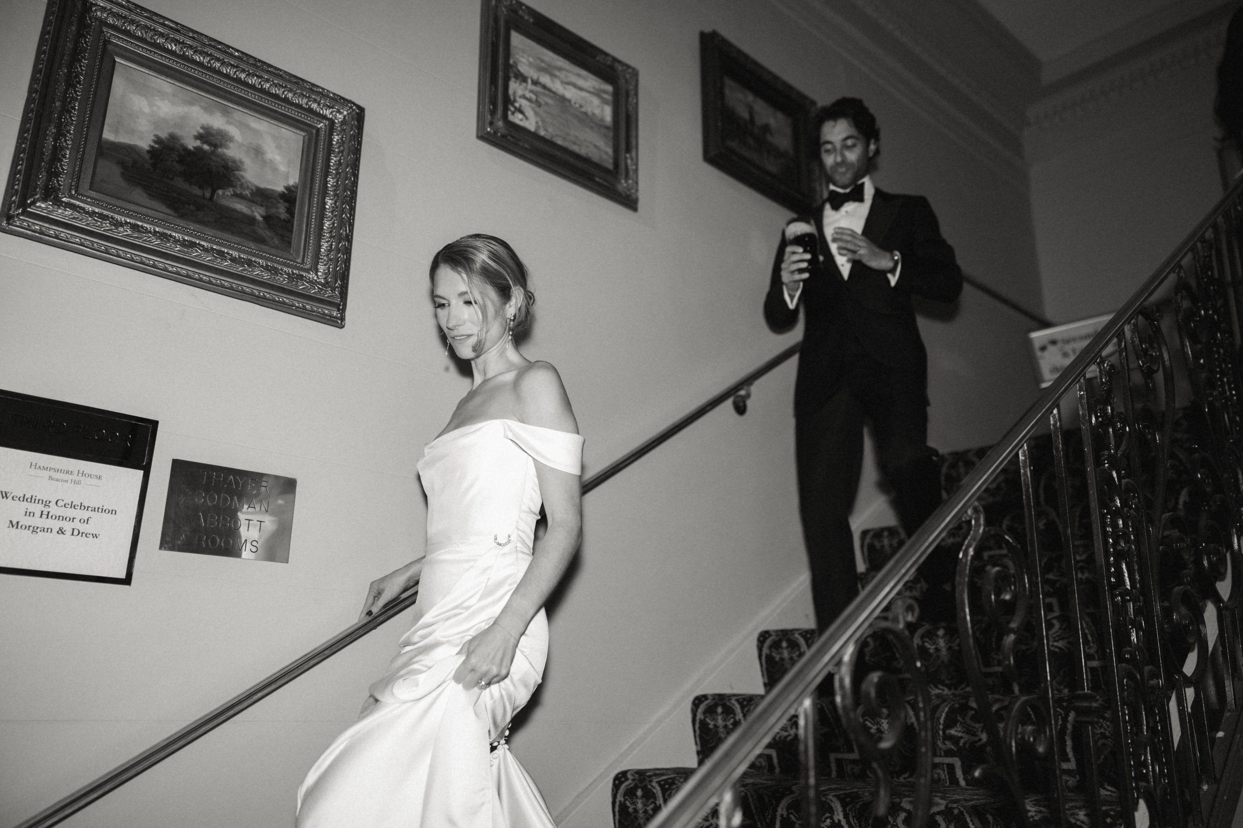bride and groom walking down stairs with border
