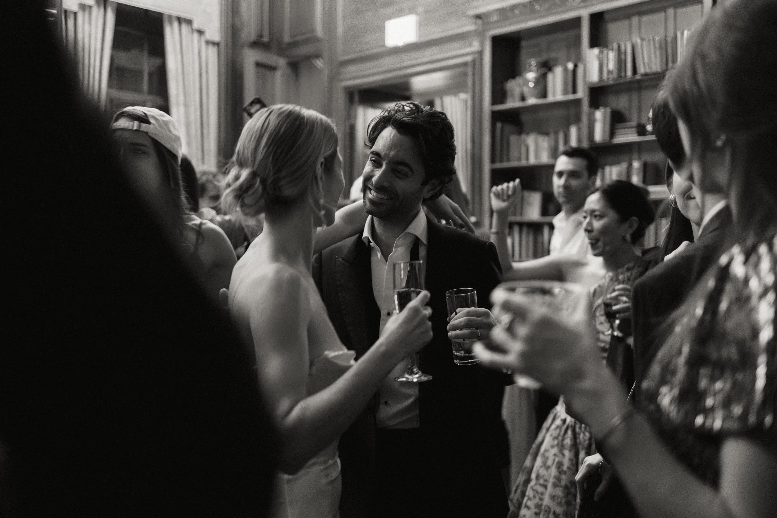 groom smiling at bride on dance floor with border
