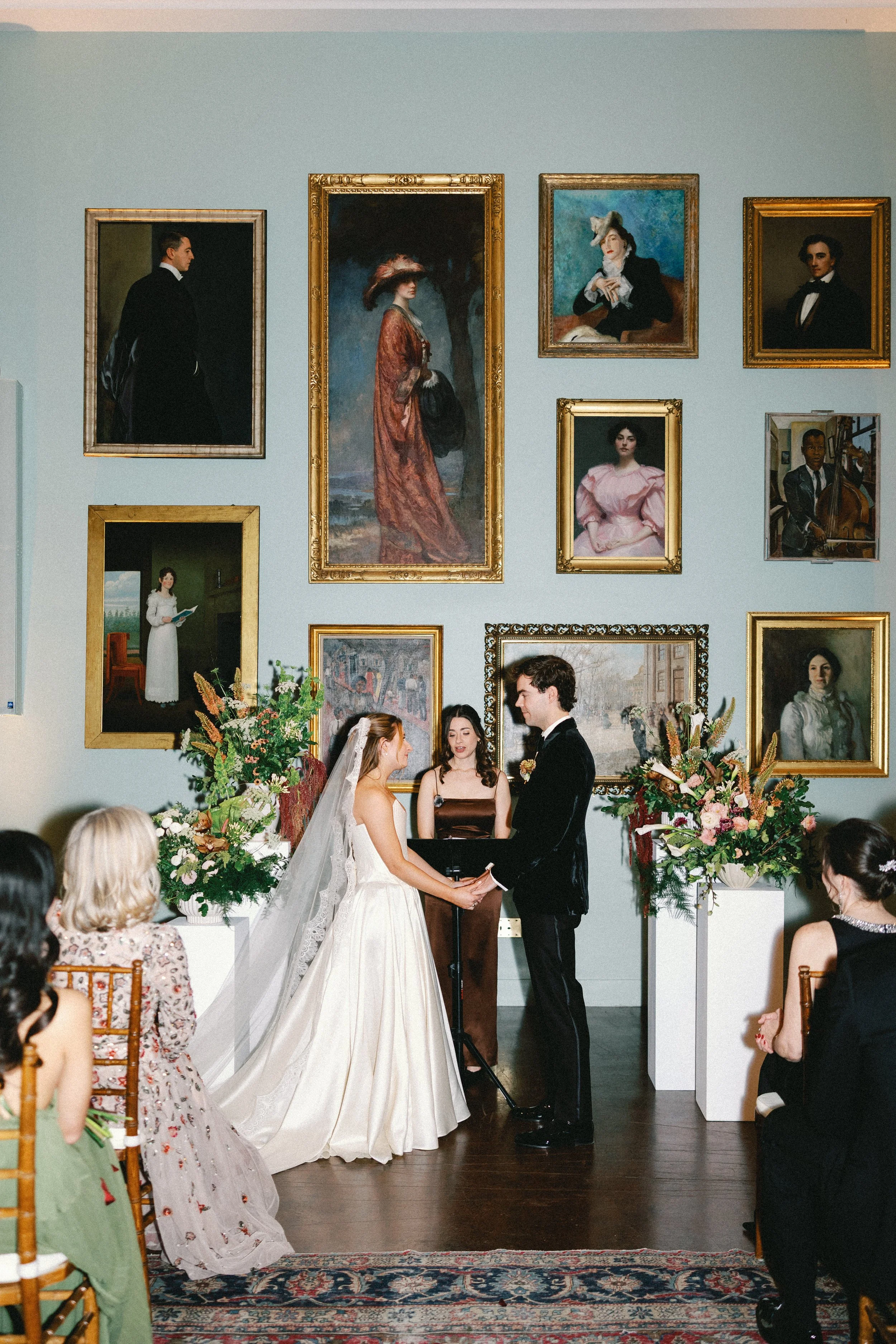 bride and groom in front of gallery wall with border