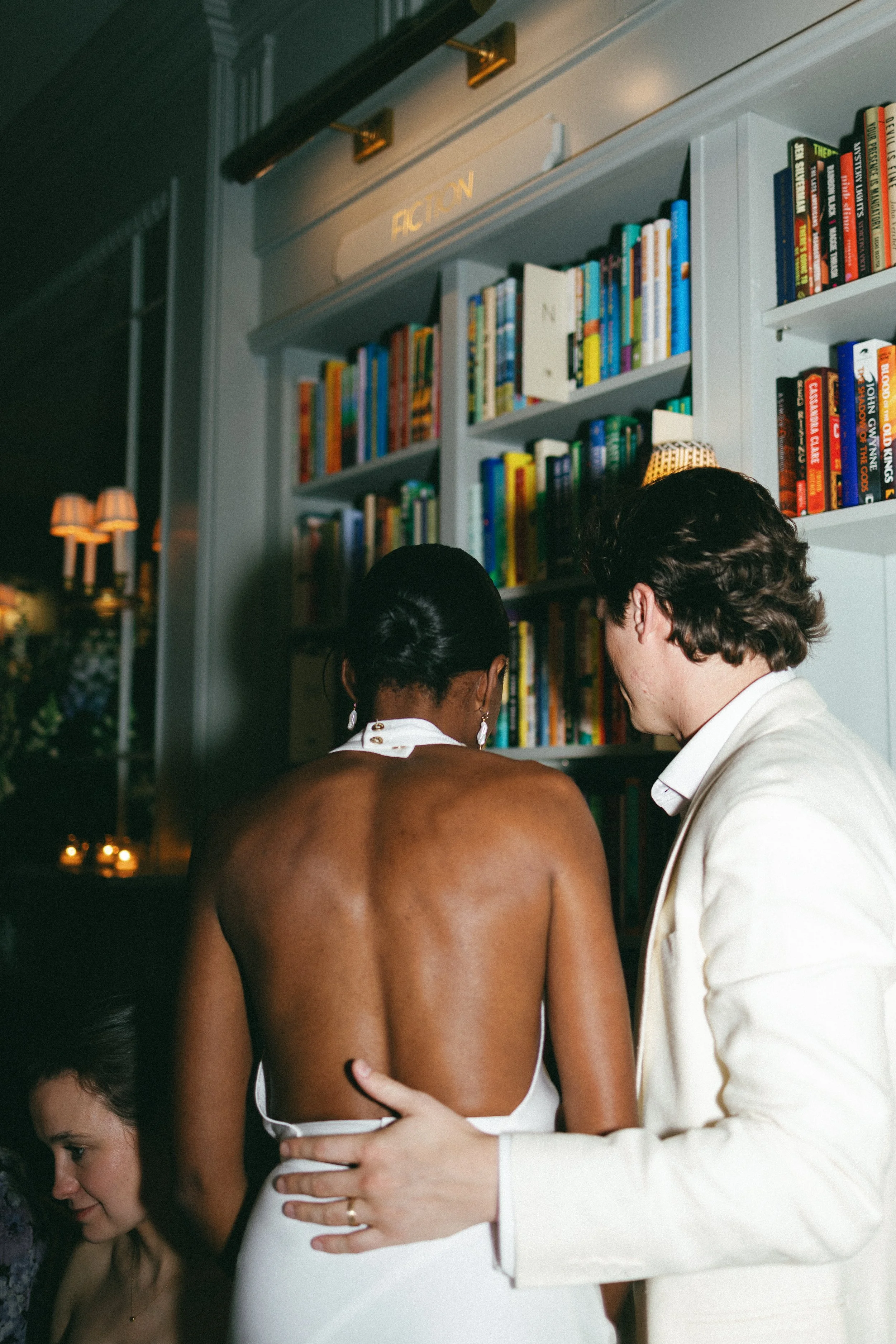 bride and groom in bookstore