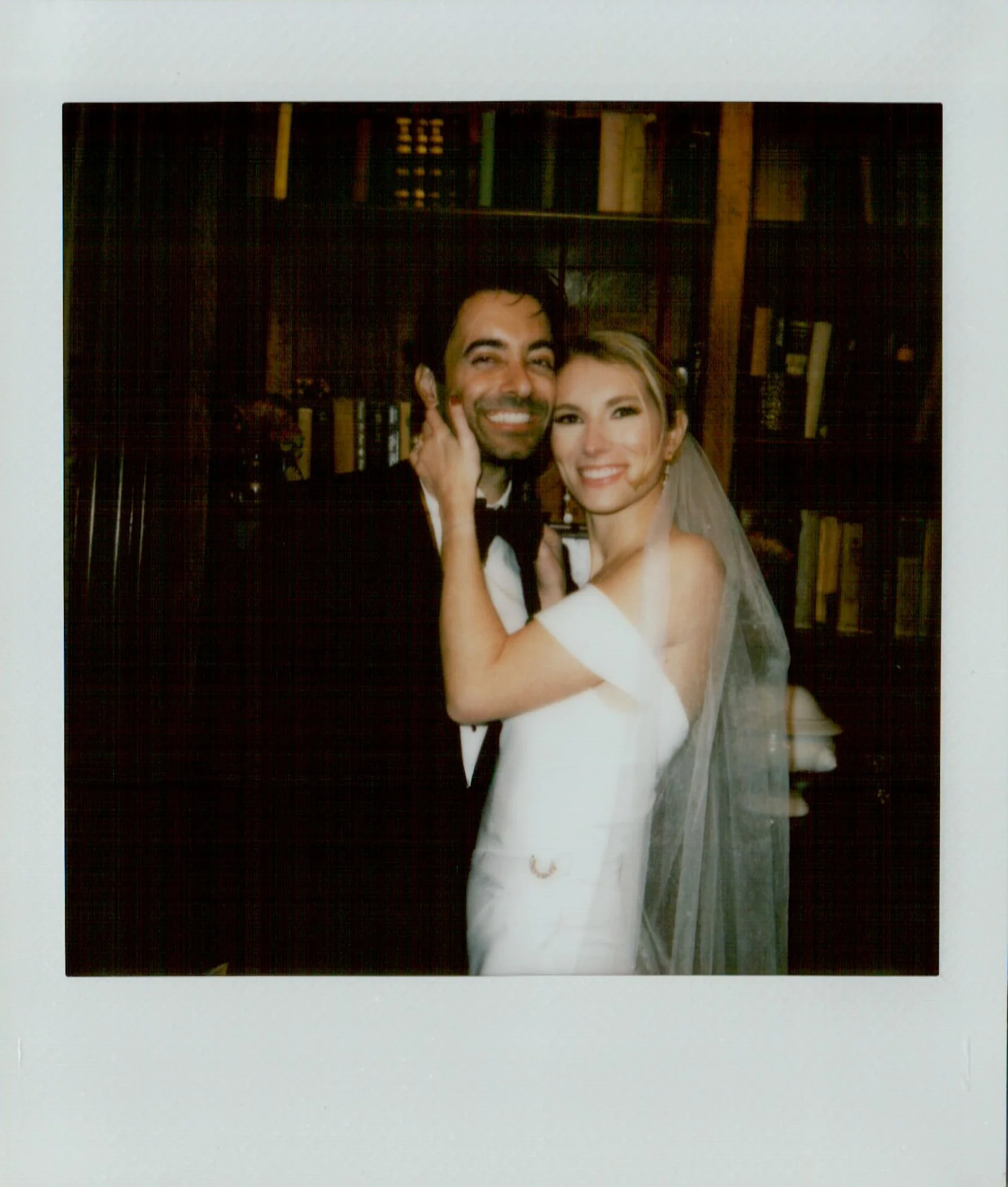 polaroid of bridge and groom embracing