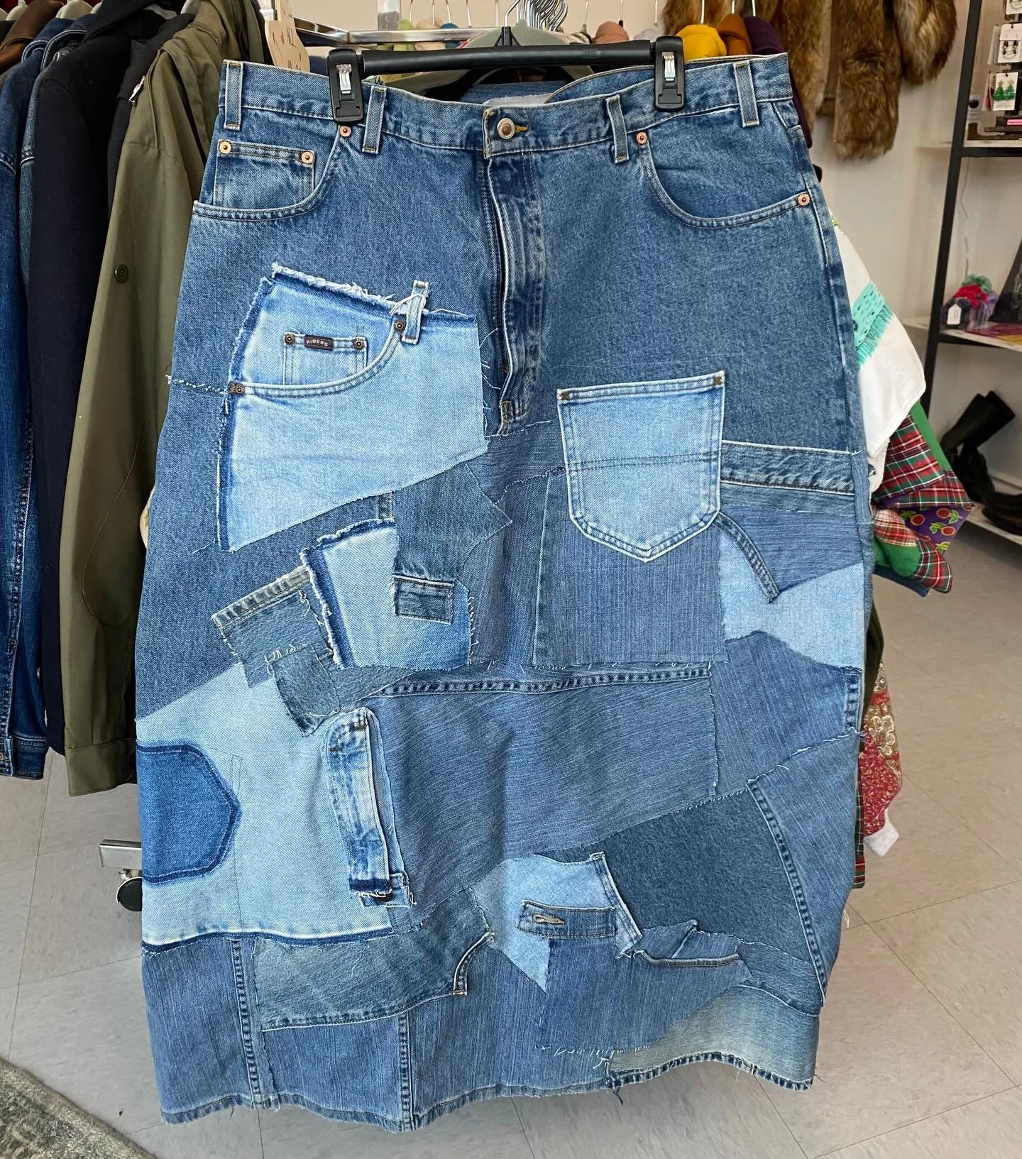 ✨DENIM 💎✨Our friend Ryan at REB Cat once again turning thrifted denim into wearable art.  This long denim skirt has such cool vibes and is full of creativity✨Come see this beauty and take home a one of a kind piece!  Fit estimate is about a 16/18ish