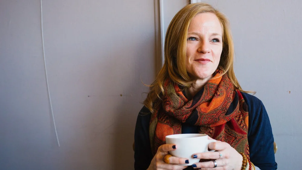 Ellie drinking a cup of coffee (but not the one that saved her life)