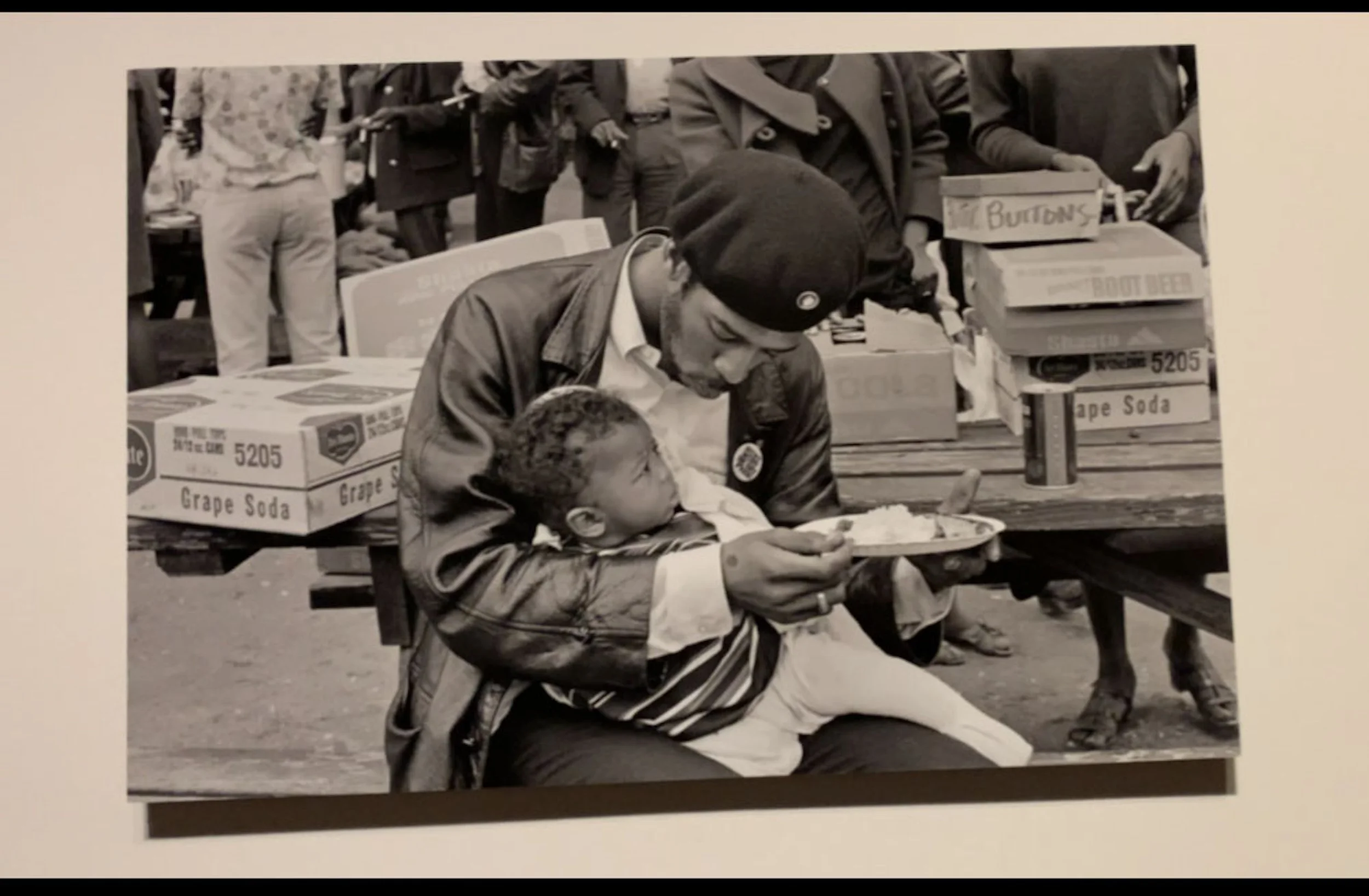 Black Panther feeding son at Free Huey Rally by Ruth-Marion Baruch
