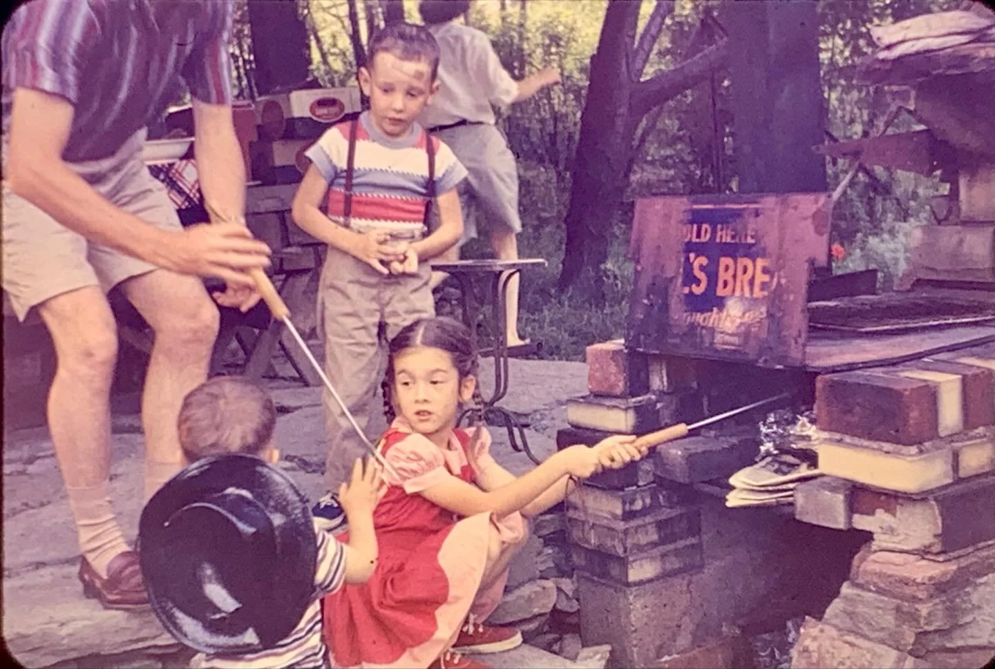 That&rsquo;s Janie Woodhouse smoking s&rsquo;mores in our backyard&rsquo;s Bar B Que circa 1958/9. Brother Eddie wearing a hat and stripes. Her brother Ricky with a bandaid on his head. Summer on Peebles Road. And after an absence of roughly 60 years