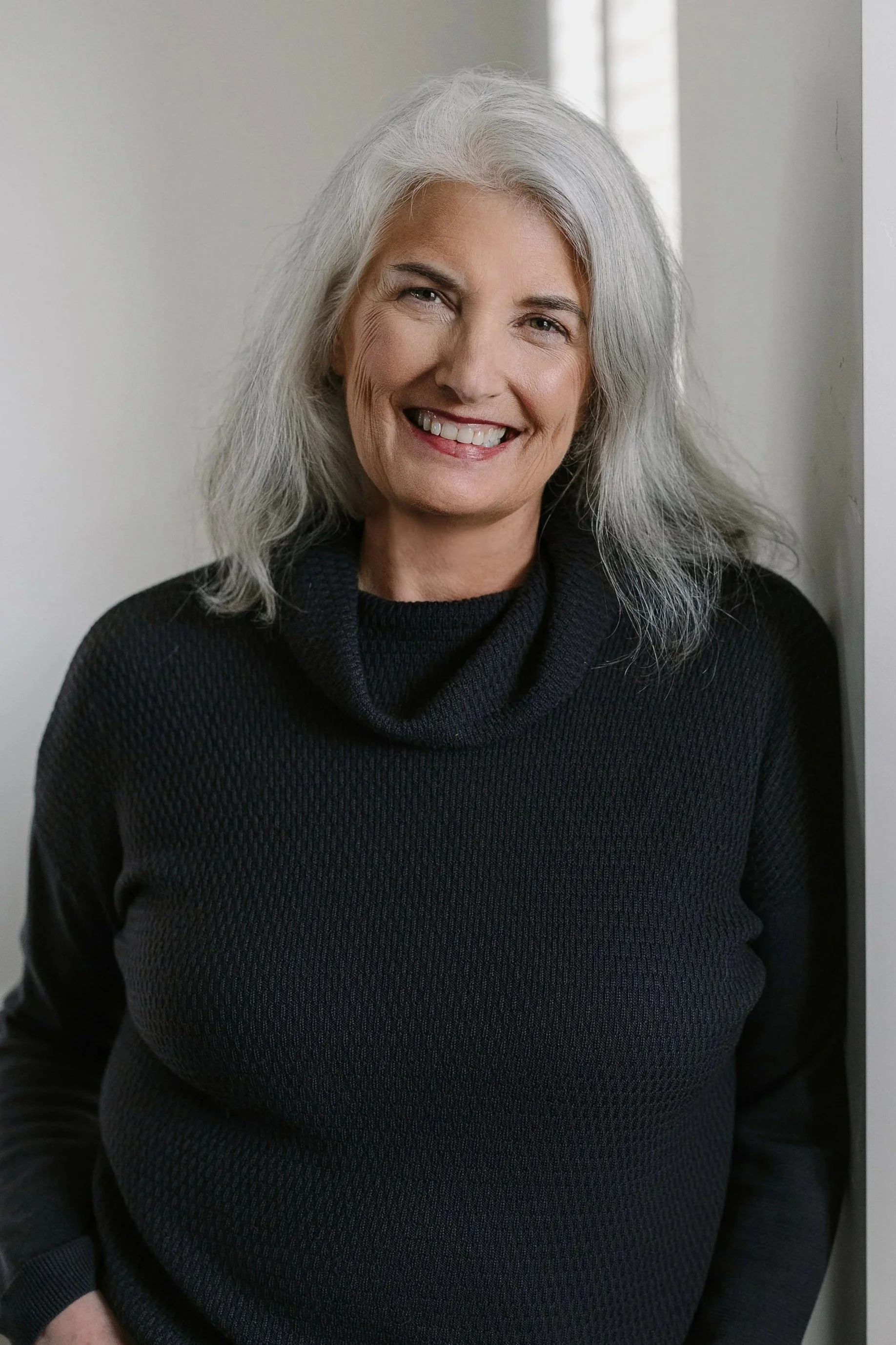 Headshot of Rochelle Lierz, smiling at the camera against a clean neutral background