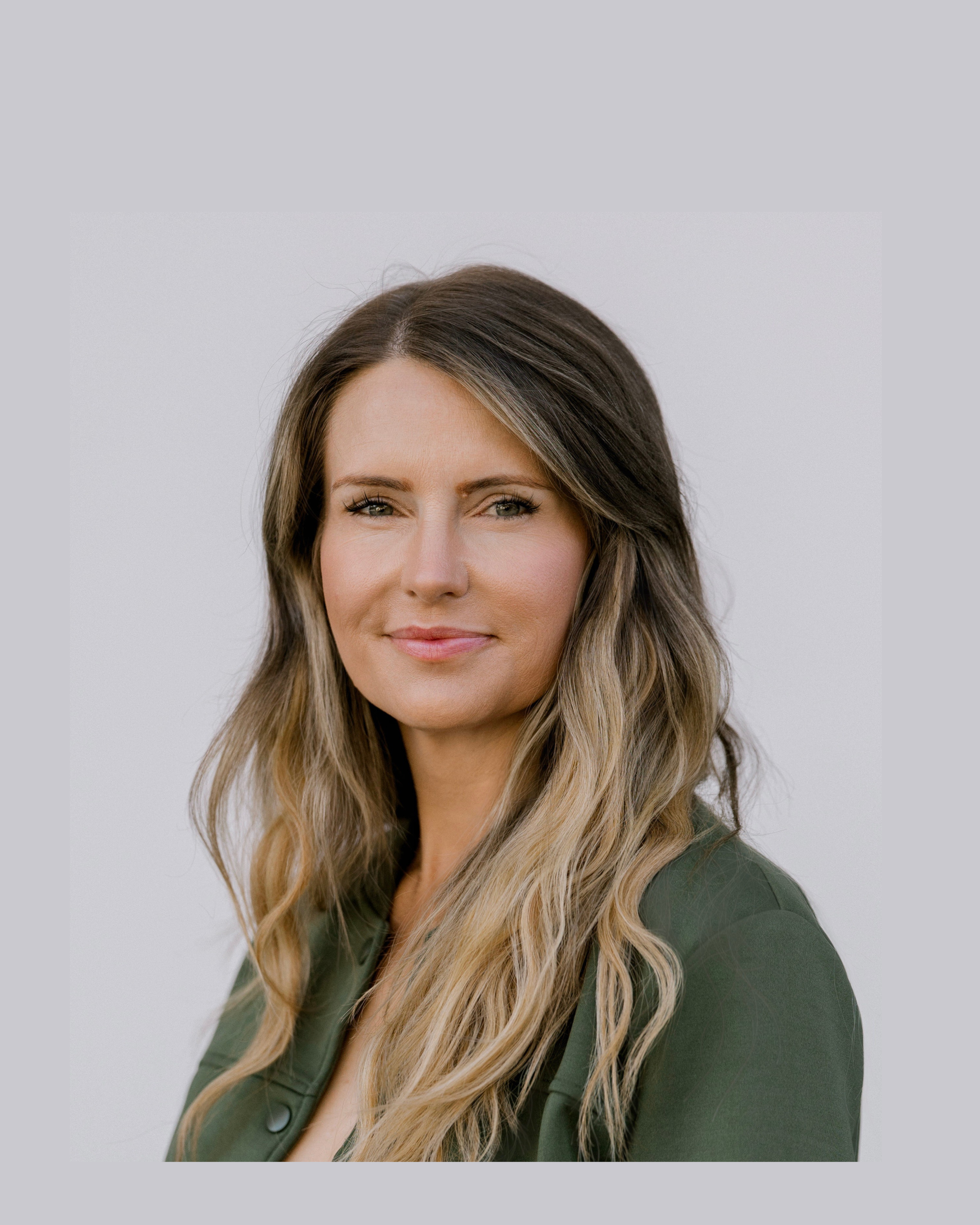 Headshot of Brie Bolopue, smiling at the camera against a clean neutral background
