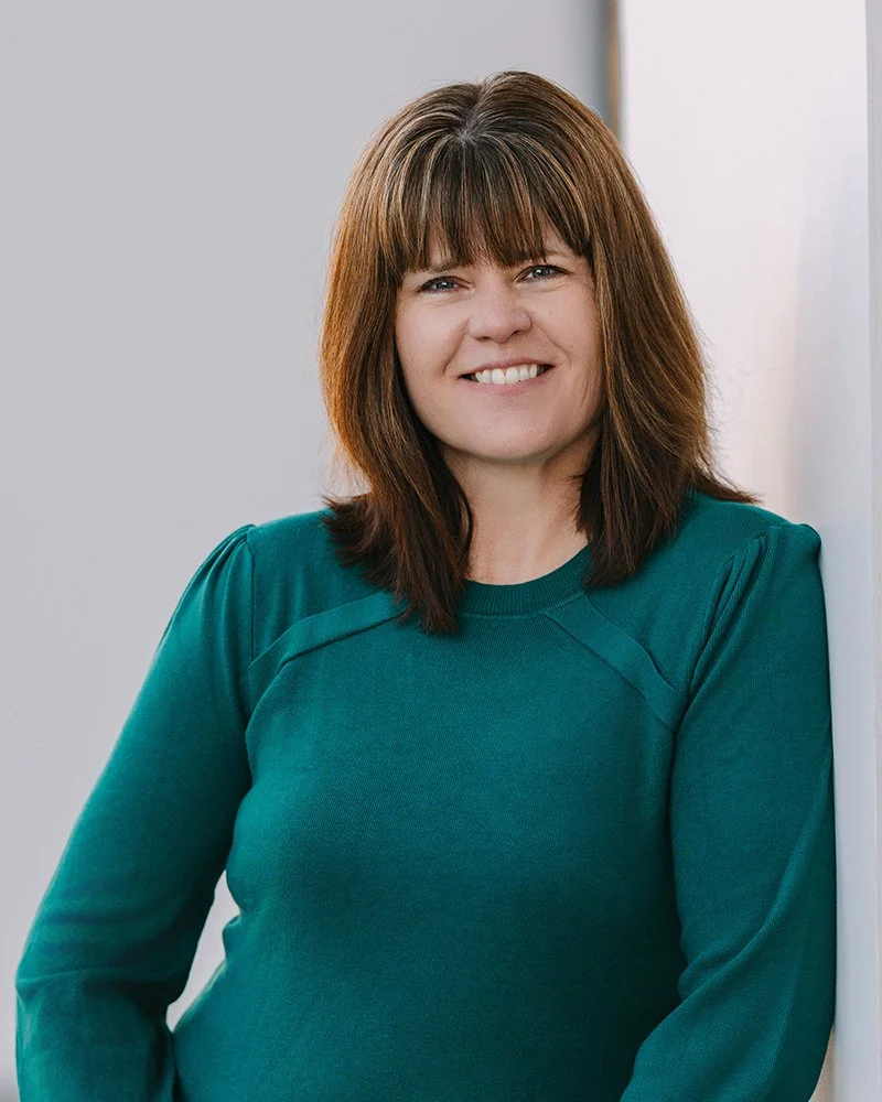 Headshot of Crystal Wilson, smiling at the camera against a clean neutral background