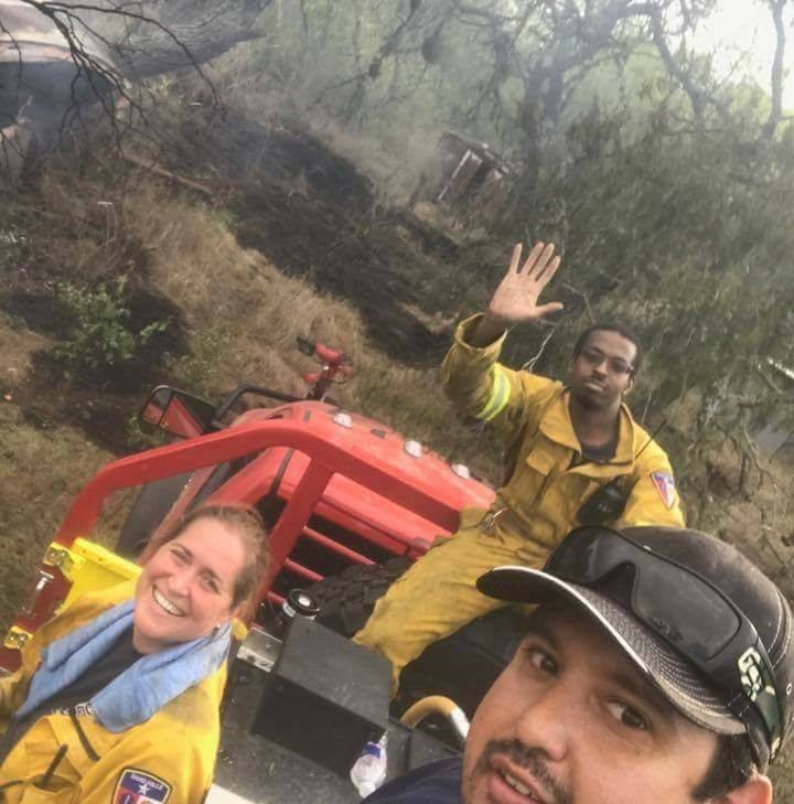 Carlos Chapa taking a selfie with Kelly Hallmark and Hamza Ball on the scene of a brush fire while searching for the last hotspots.