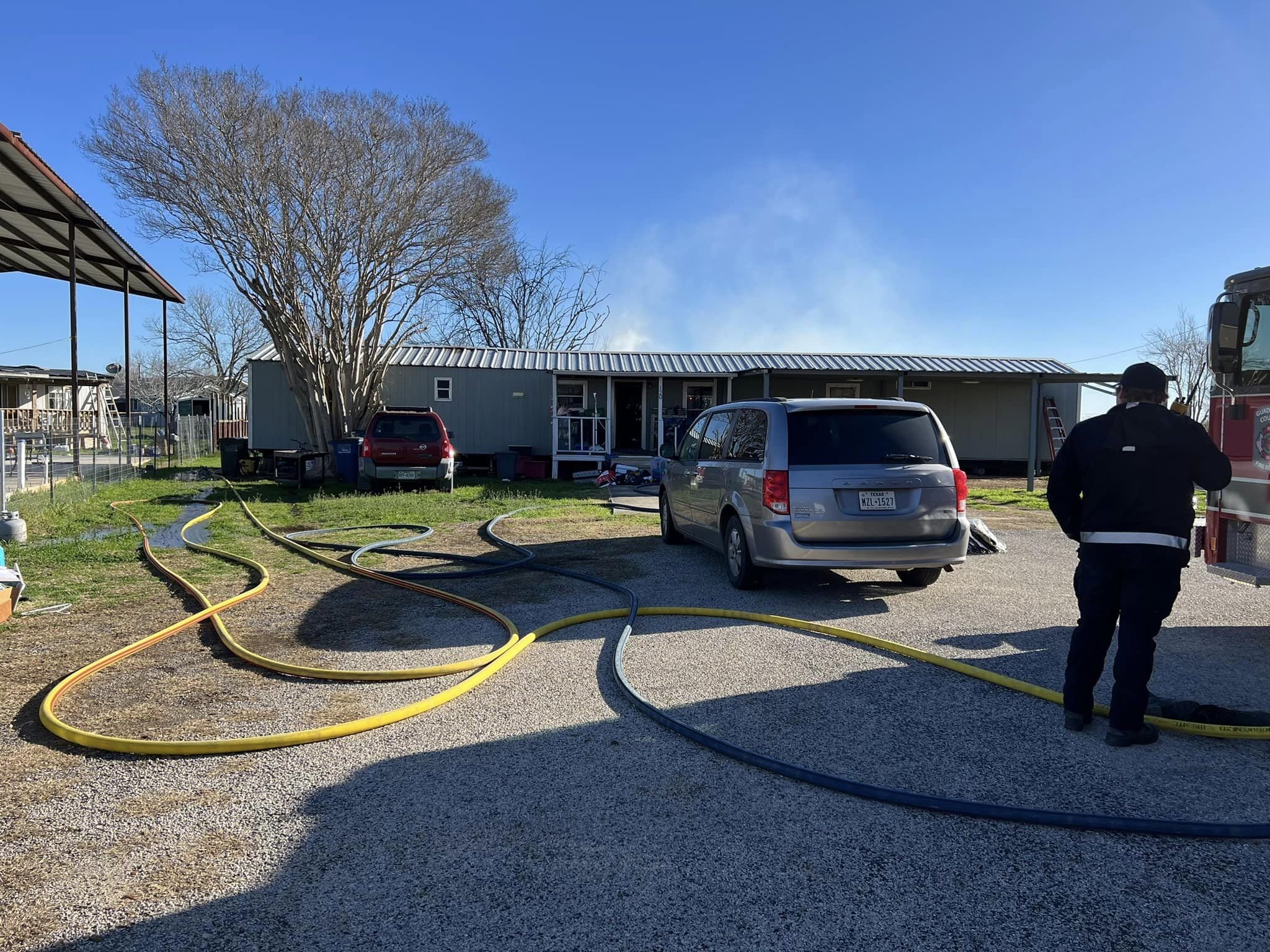 SHVFD and GCFR Personnel working together to extinguish the rear of the mobile home and add-on shed.