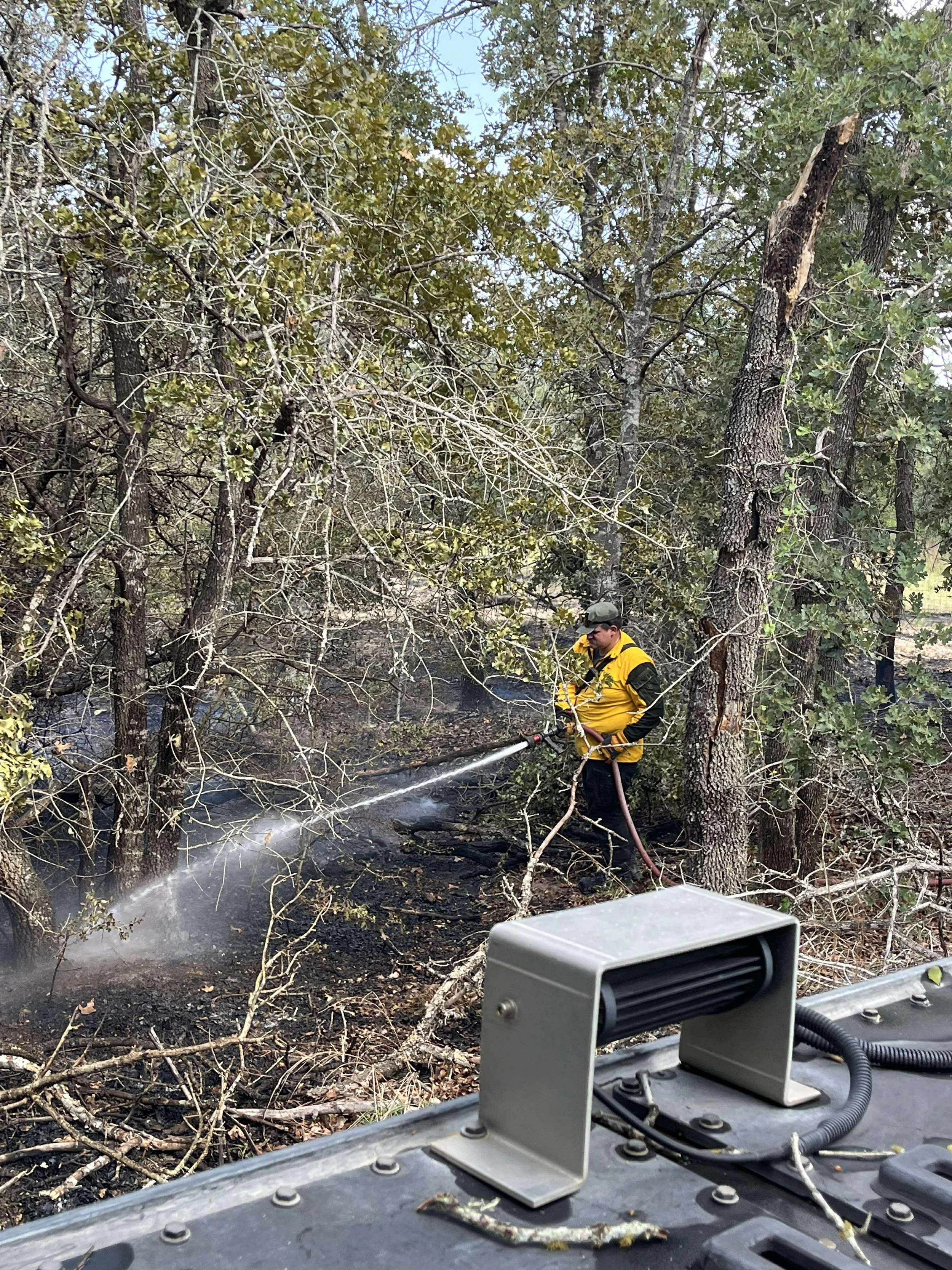 FF/AEMT Beicker extinguishing hotspots on a brush fire.