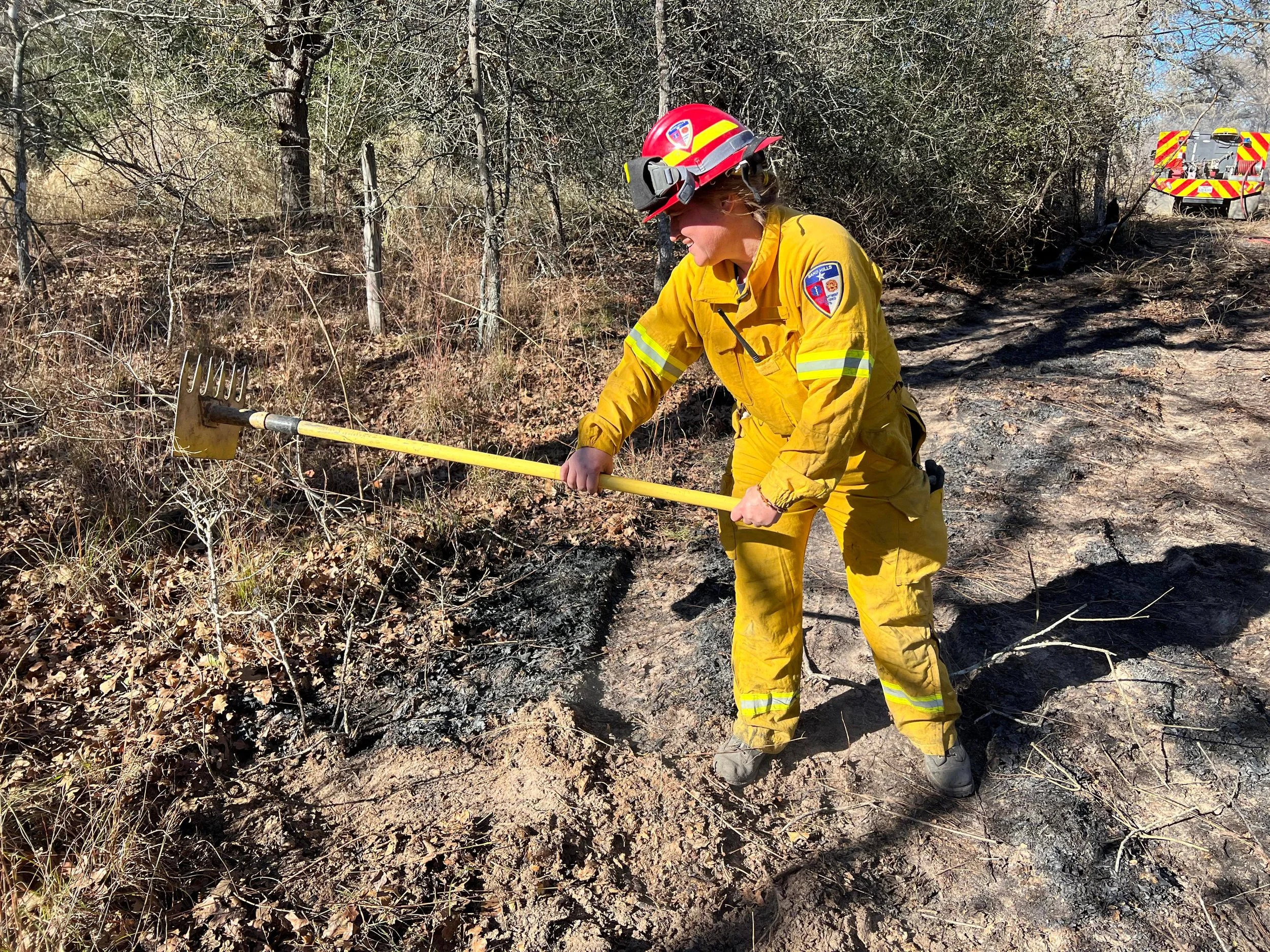 Assistant Chief Hallmark, Then Captain, Assisting in mop-up operations on a brushfire.