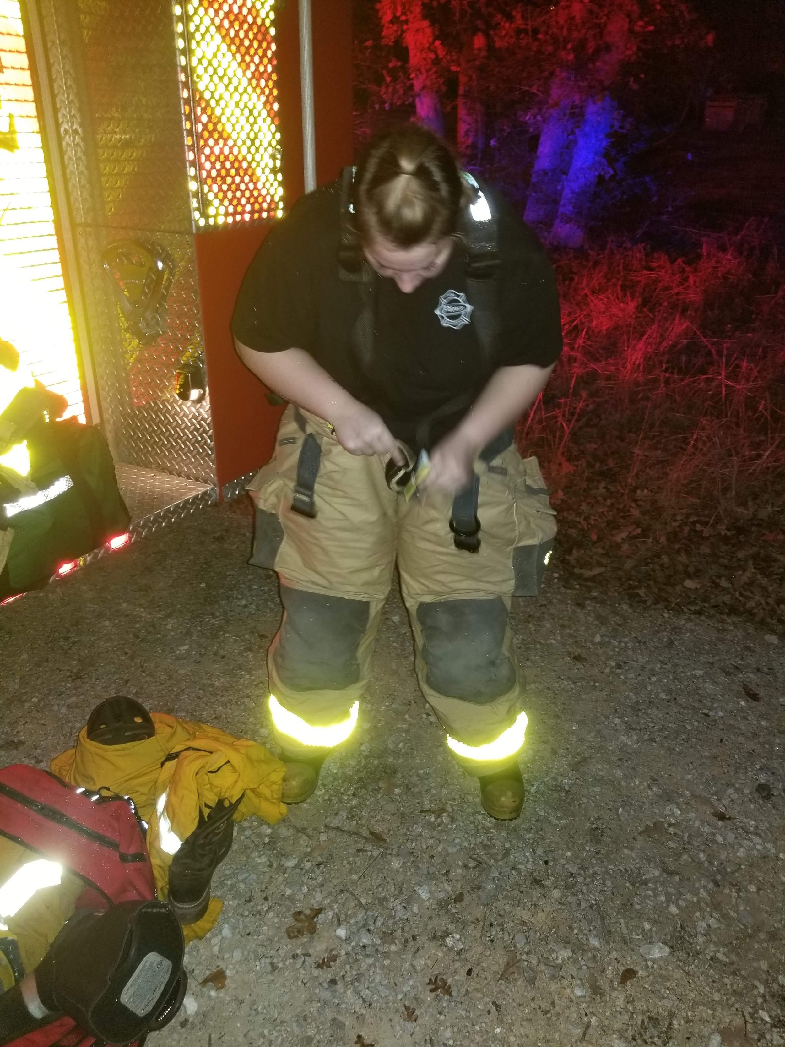 Cheyenne Hallmark putting on PPE prior to entering the fire scene.