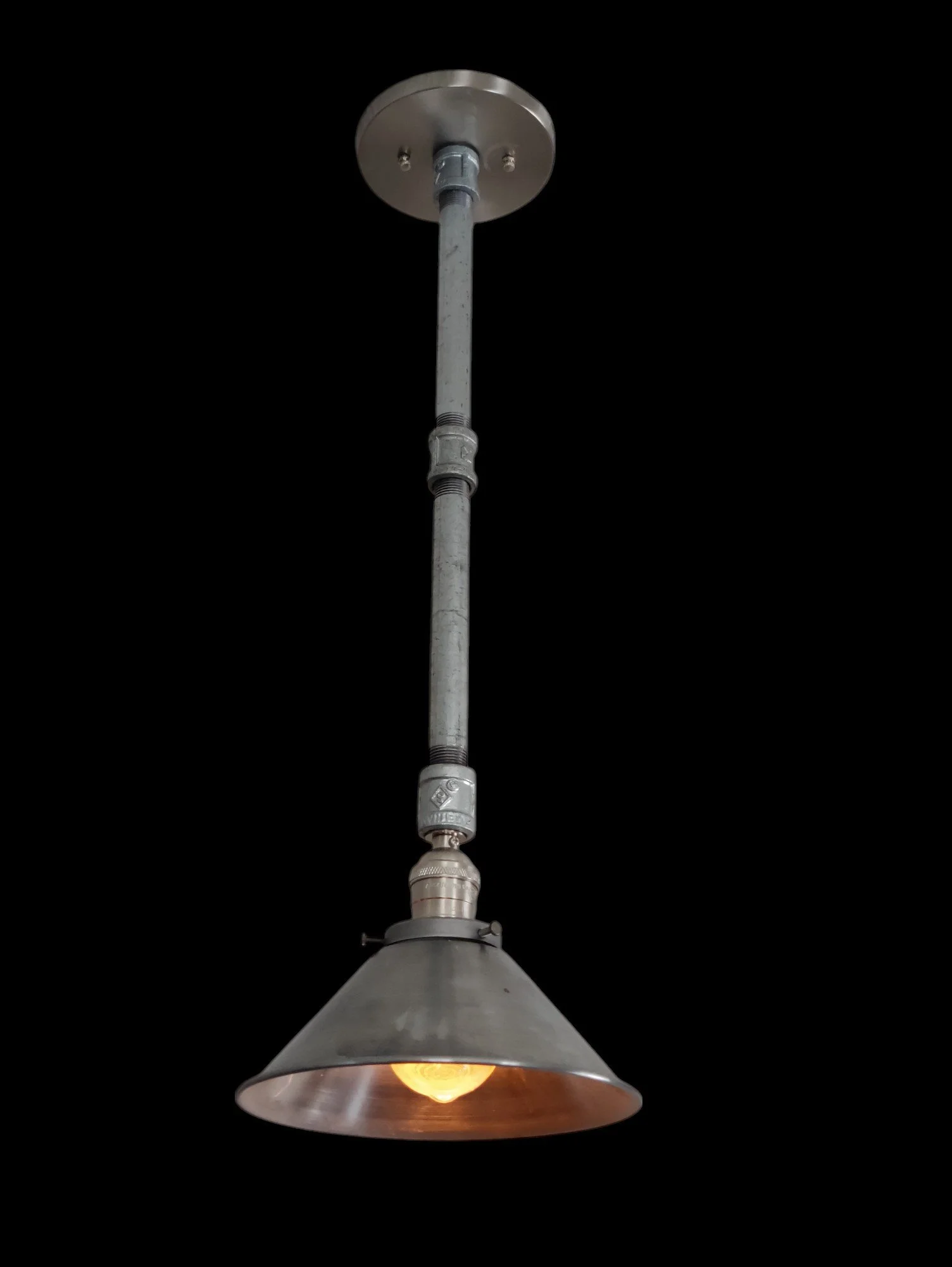 Industrial hanging lamp with metal shade and exposed bulb, suspended from ceiling mount