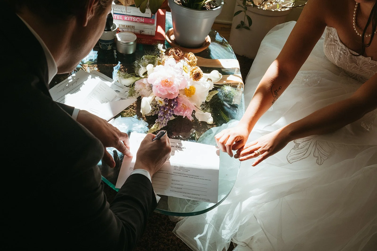 Couple signing marriage license during an intimate wedding ceremony