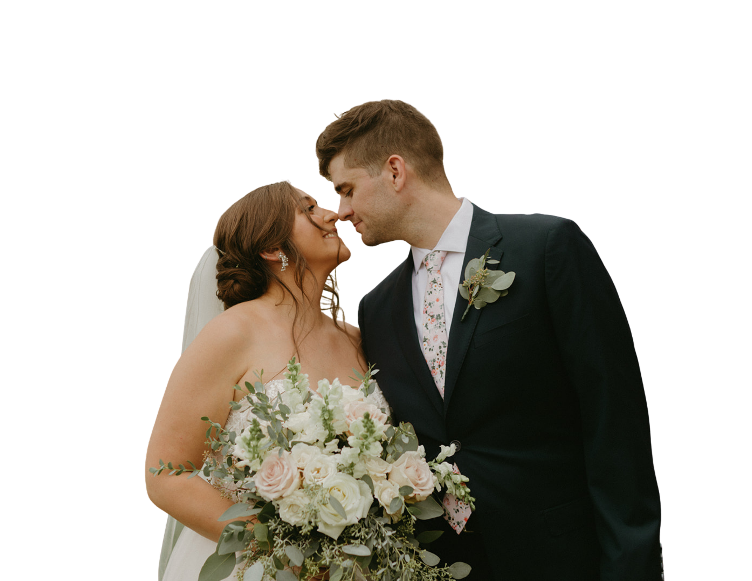 A bride and groom pose for a picture while smilng