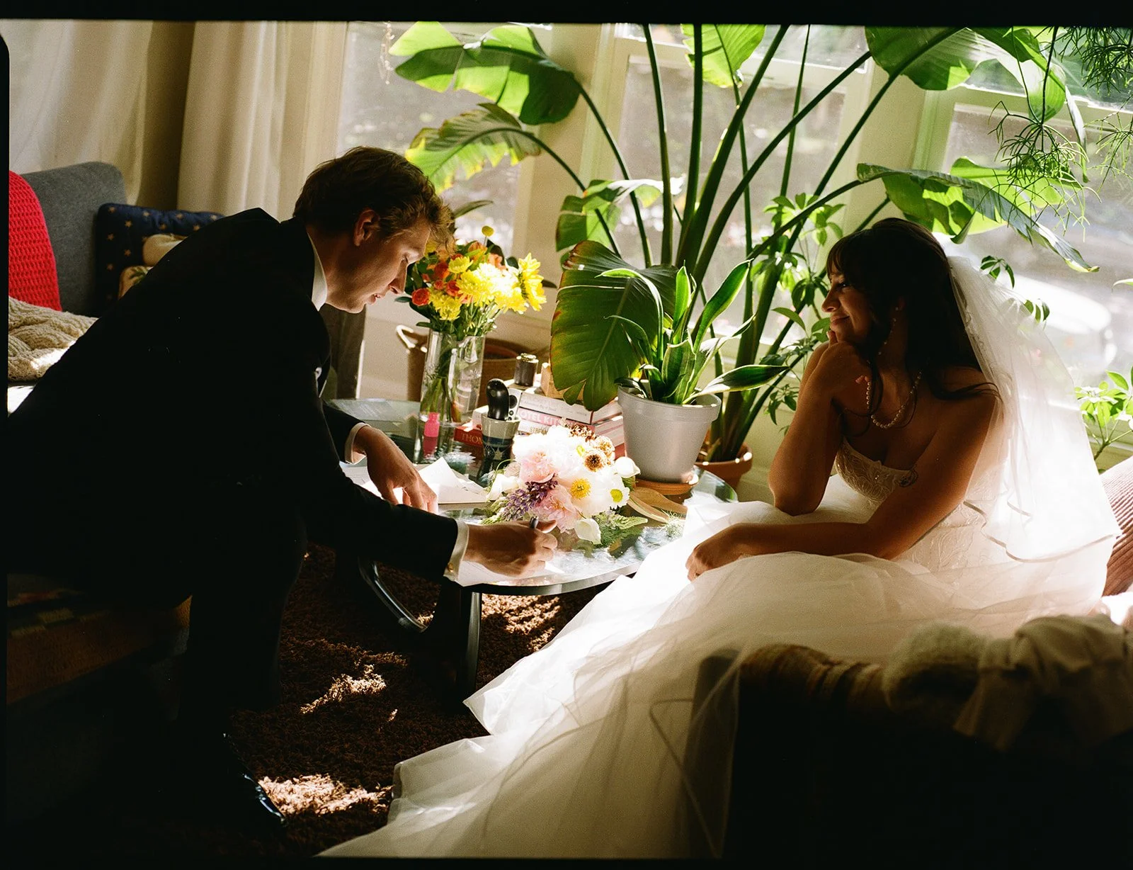 Couple signing marriage license during an intimate backyard wedding reception