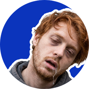 A young man with messy red hair and facial hair, eyes half-closed, mouth slightly open, against a blue background.