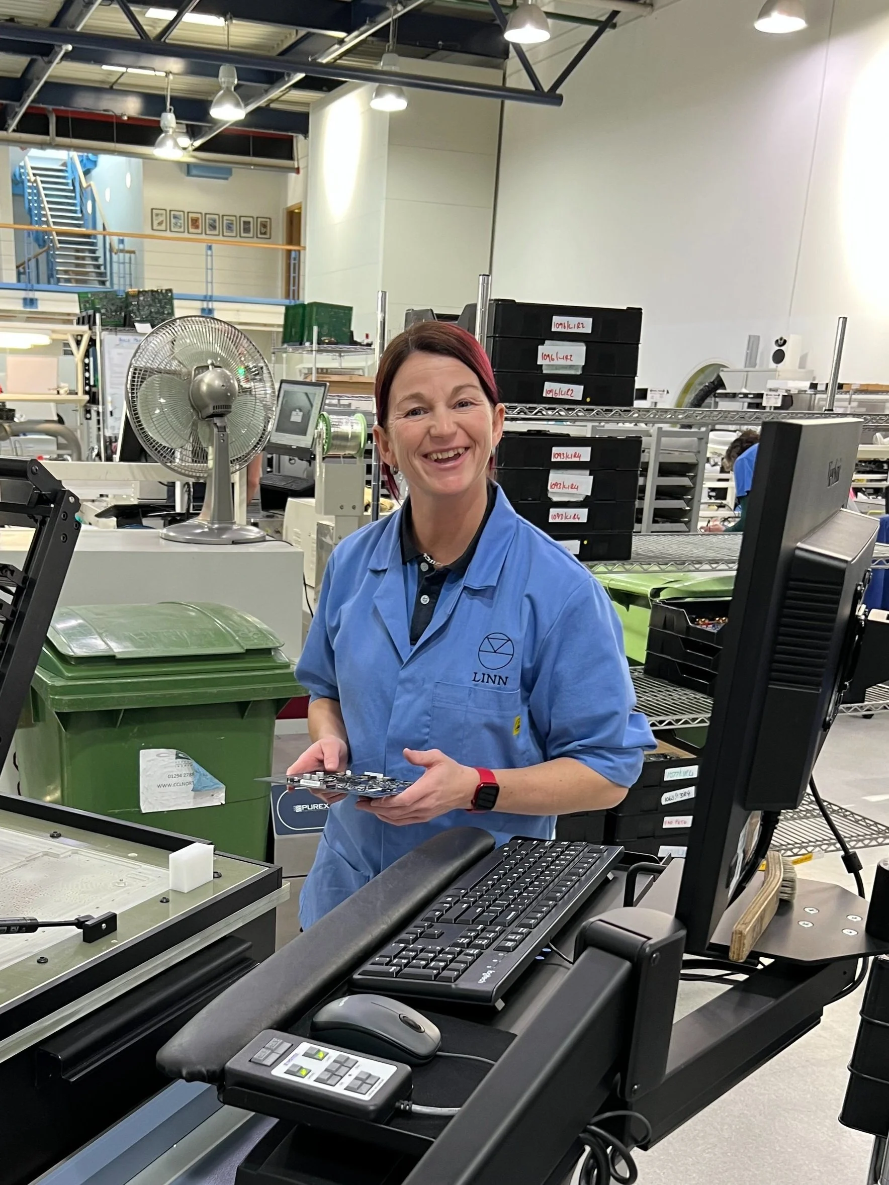 Linn employee Gayle smiling while working at the Linn factory in Glasgow