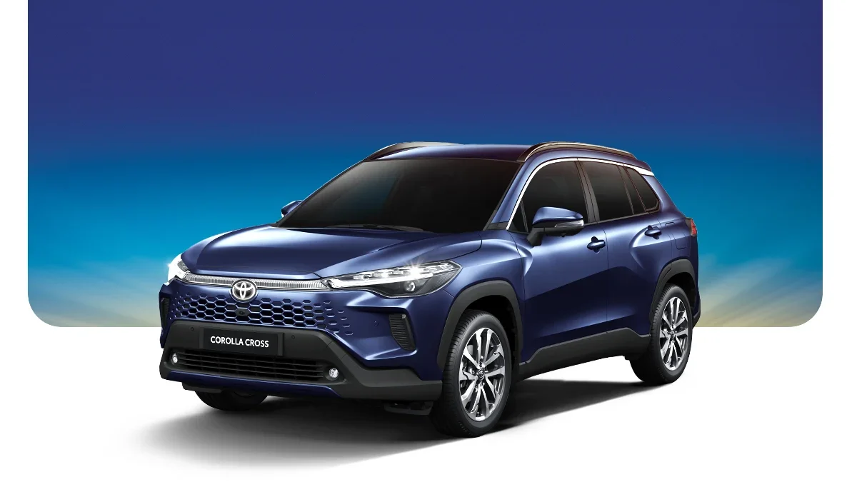 A blue Toyota Corolla Cross SUV with tinted windows against a gradient sky background.