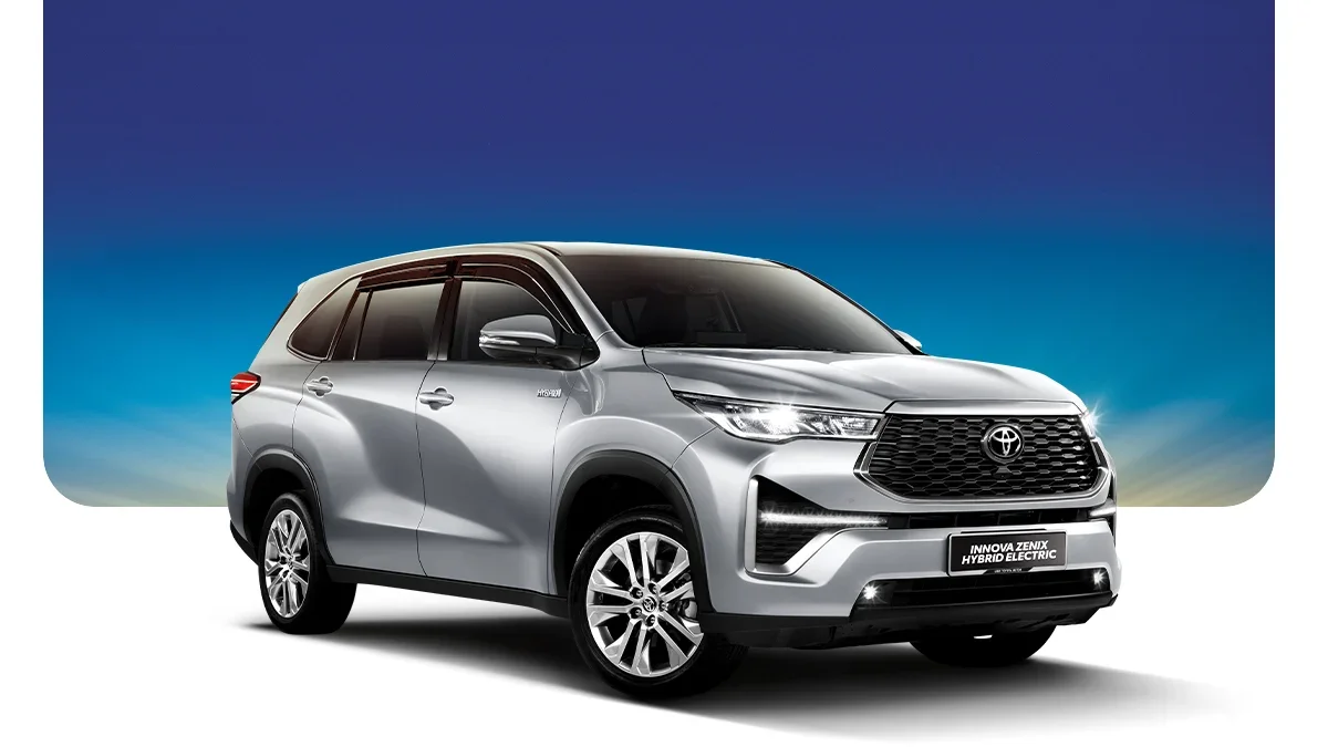 Silver Toyota hybrid SUV parked against a gradient blue sky background with white to dark blue color transition.