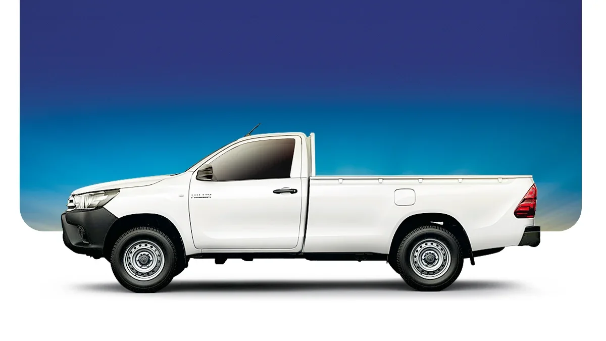 White pickup truck parked against a background of a blue sky transitioning from deep blue at the top to lighter blue at the horizon.
