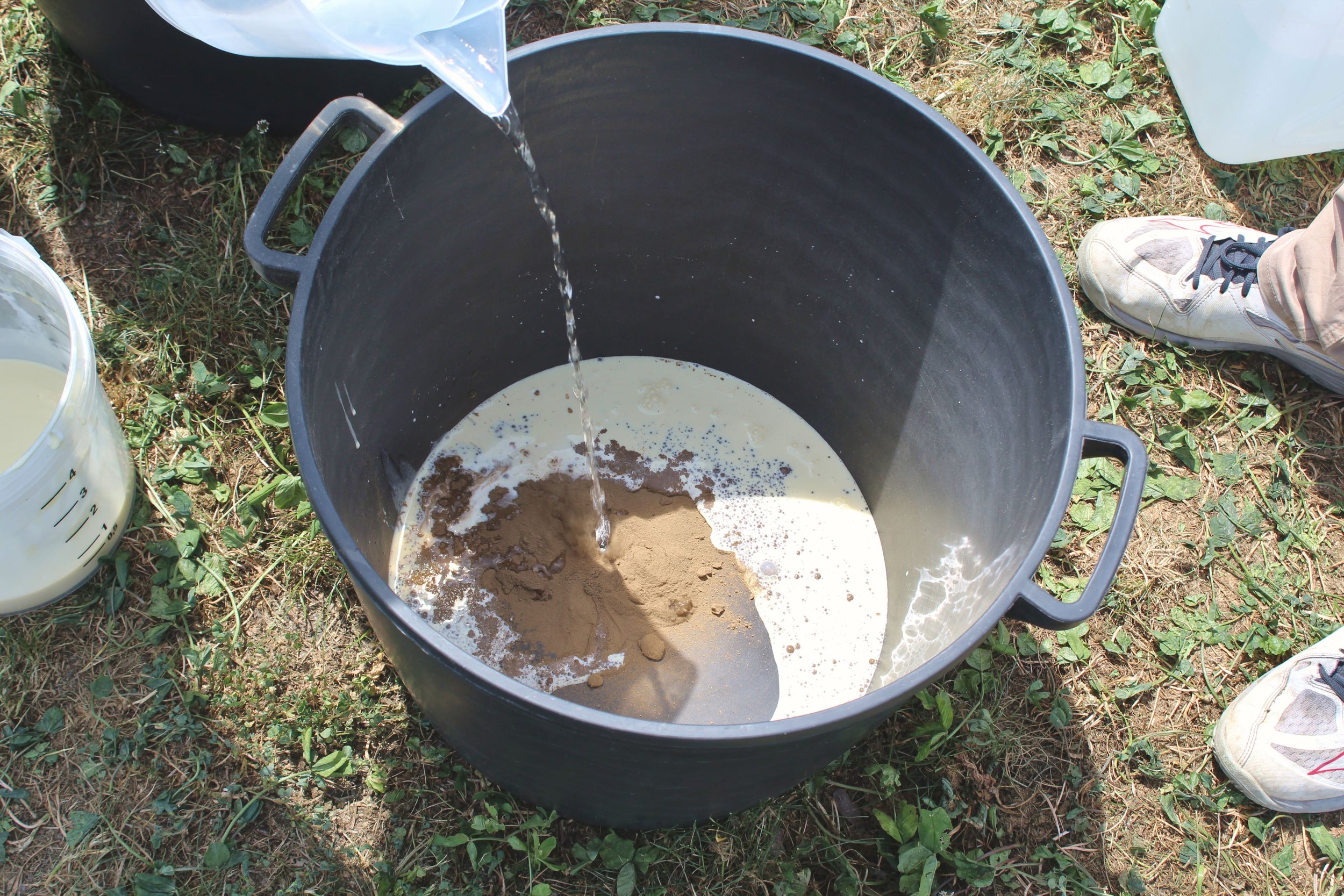 Fifteen Thousand Steps by Davide Sozio, a participatory art project with IUAV University of Venice, 2026 - participants preparing pigments on site.