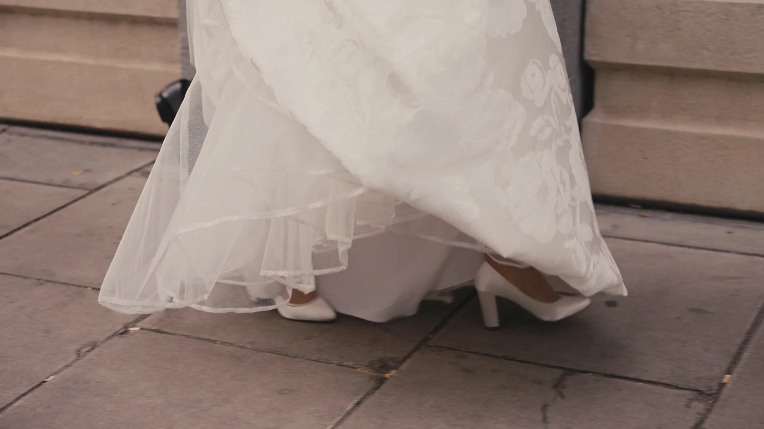 Brides feet walking on pavement