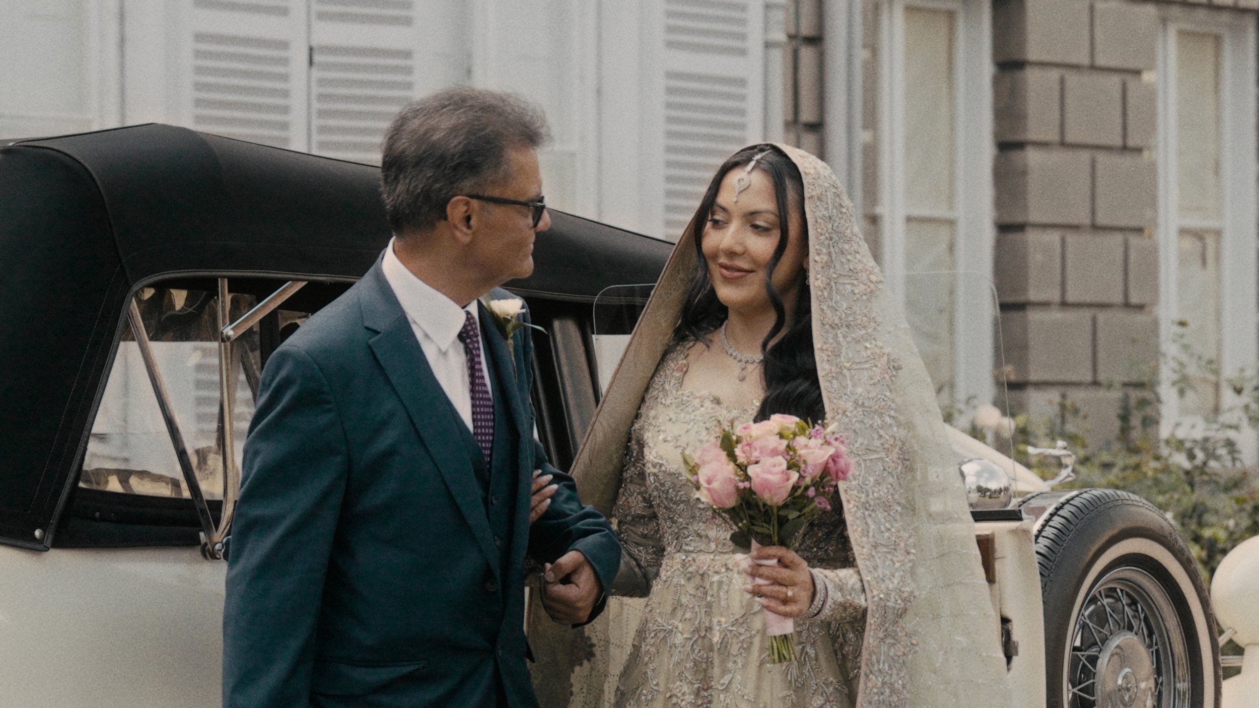 Bride and father of the bride getting out of car