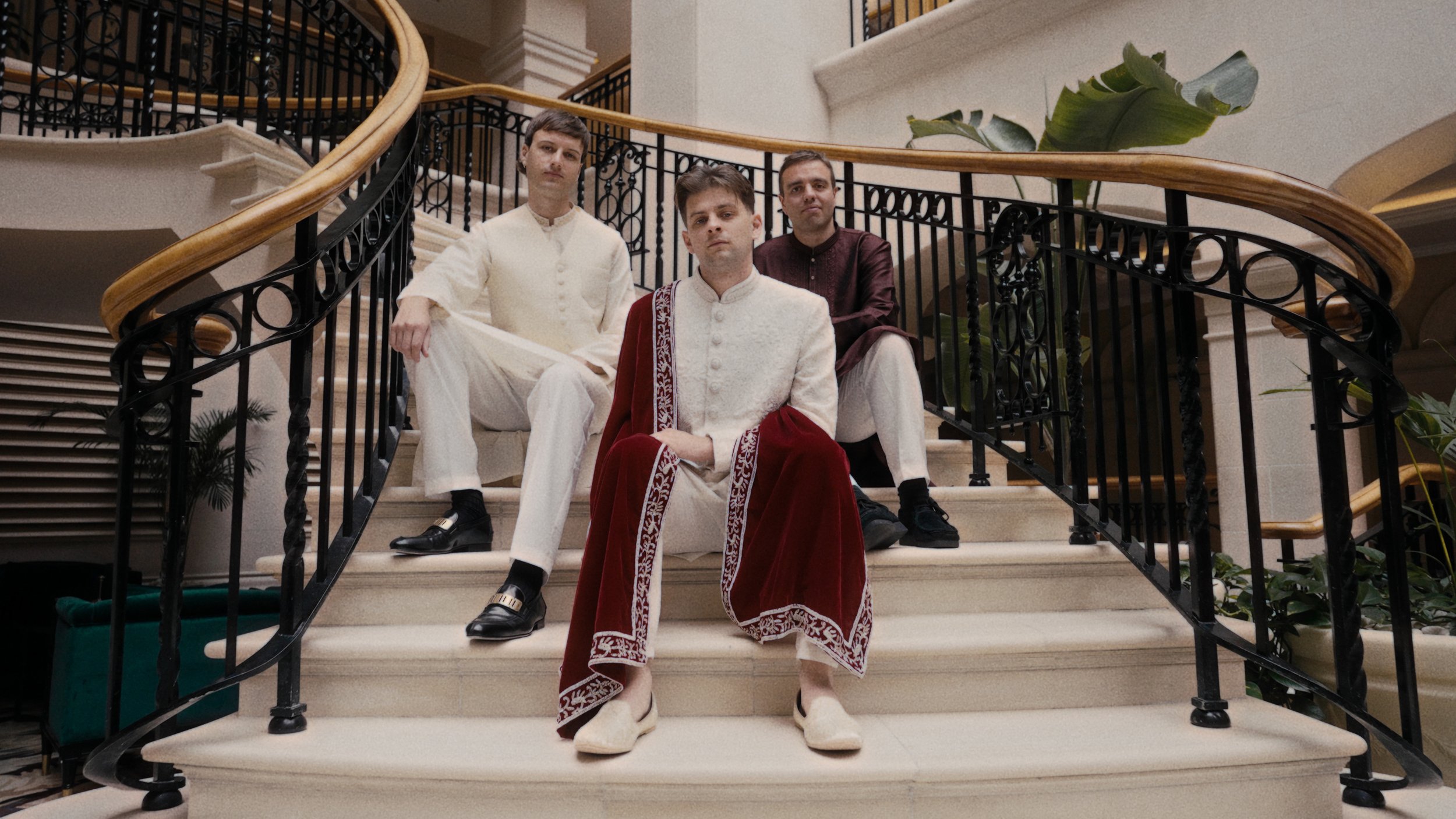 Groom and groomsmen sat on the stairs of the Landmark hotel