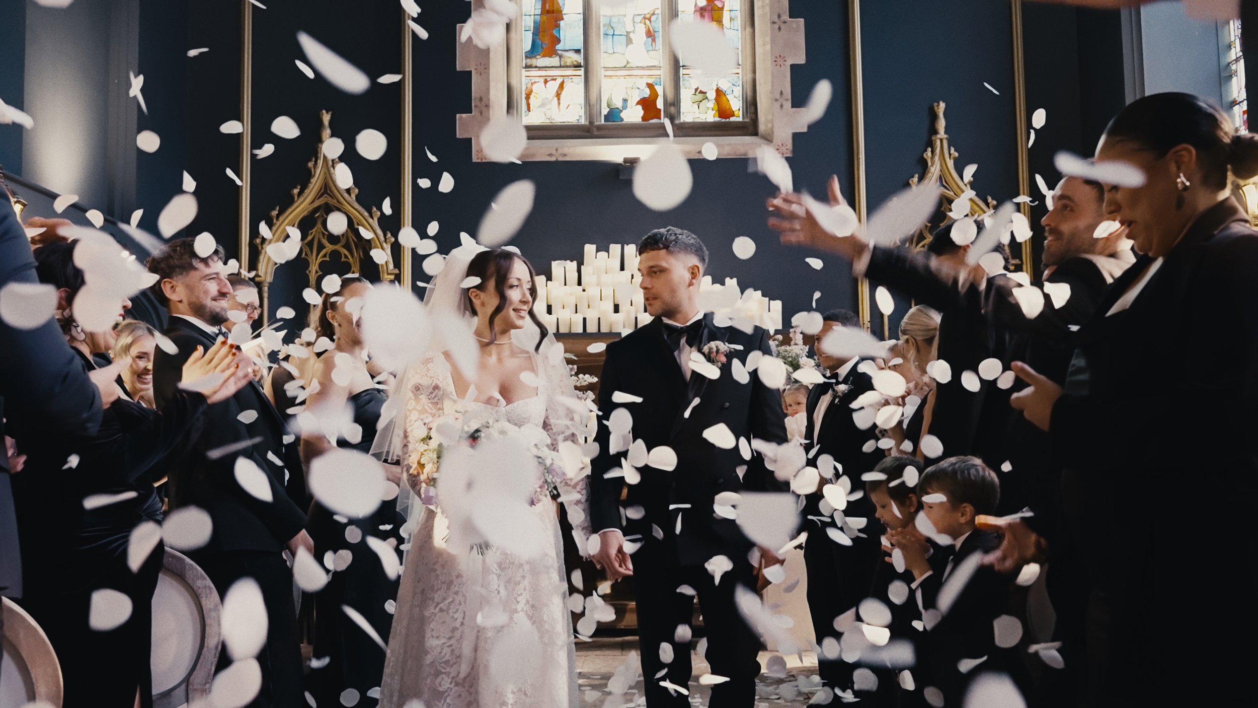 bride and groom walking down the aisle with confetti