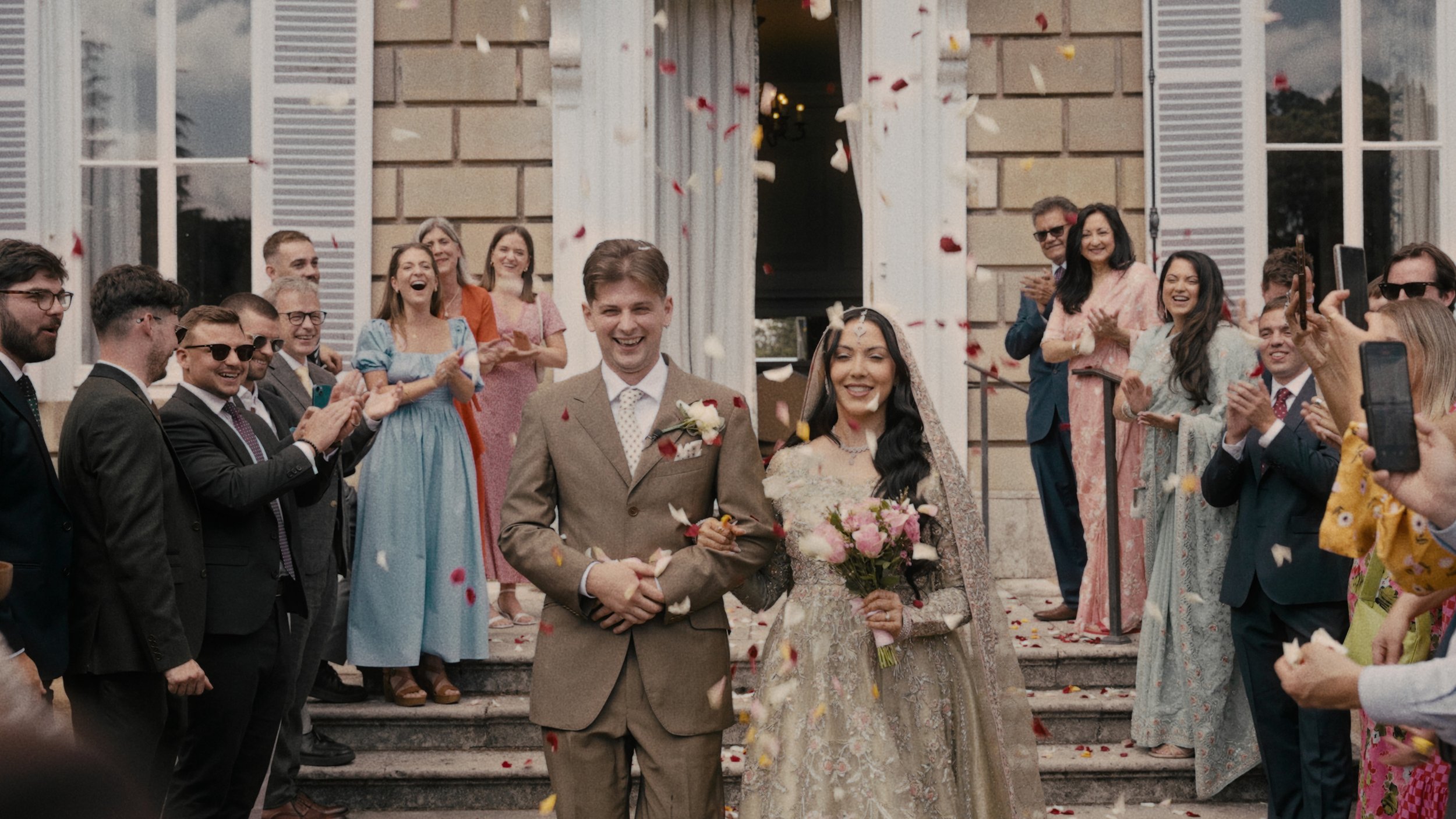 bride and groom walking through confetti