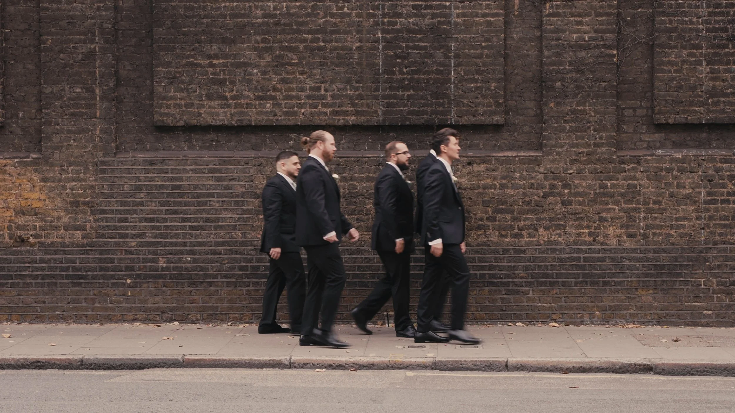 Groomsmen walking down street
