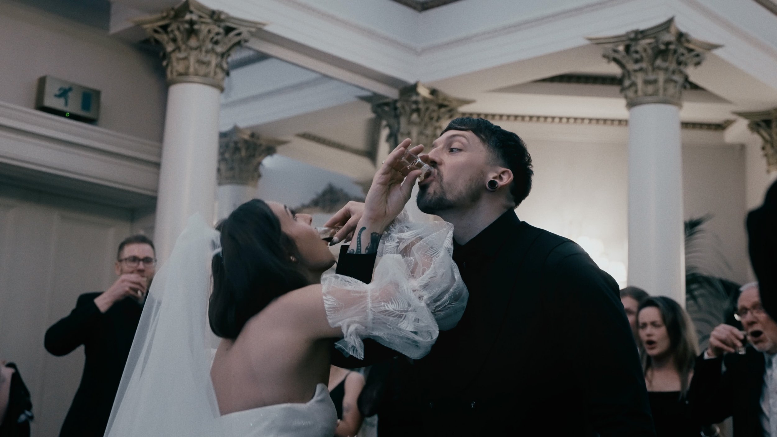 bride and groom taking a shot of baby Guinness