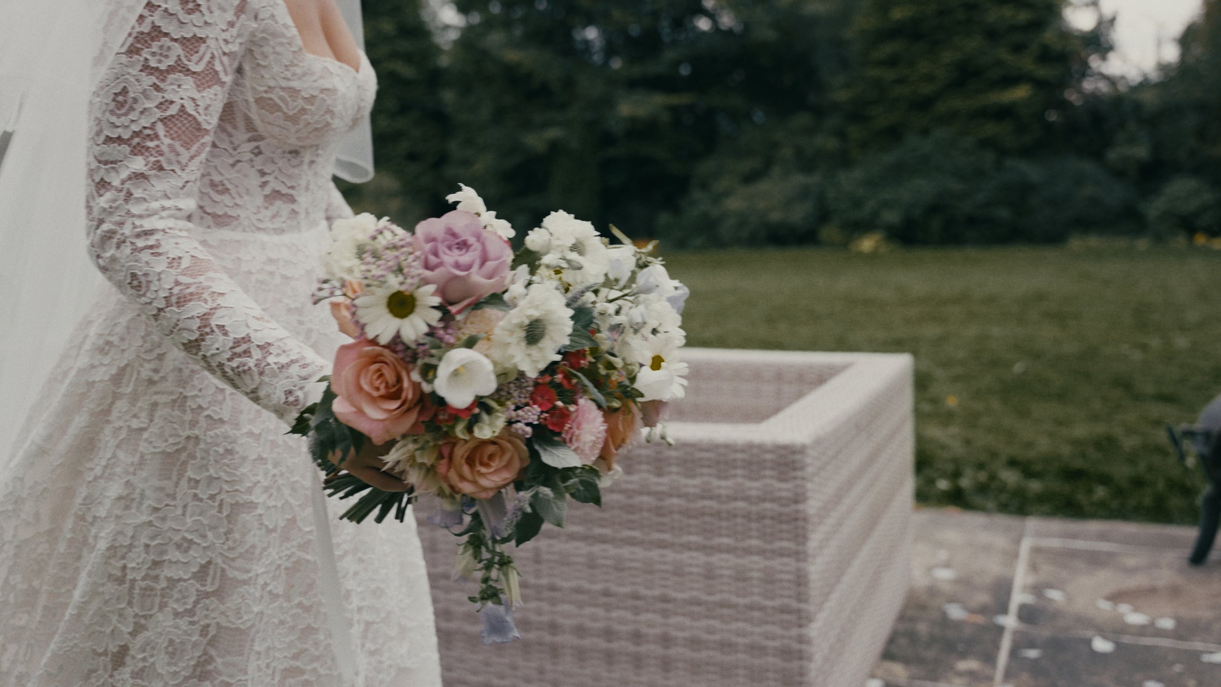 Bride walking with bouquet of flowers