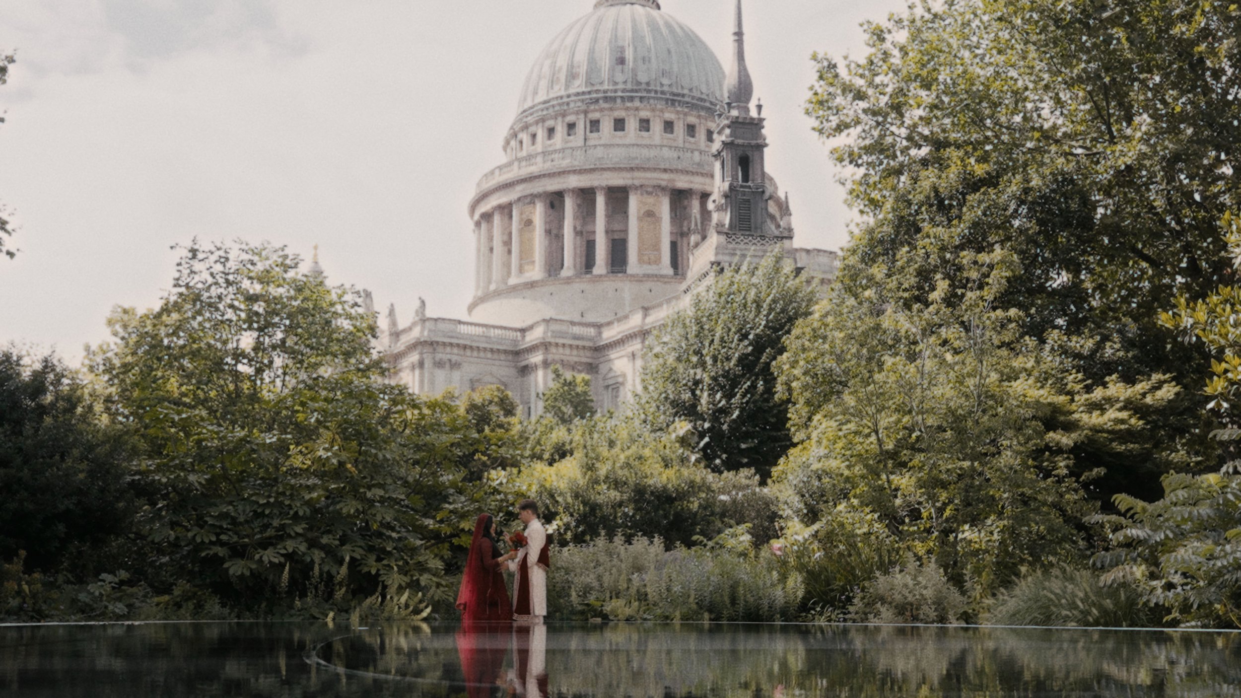 bride and groom standing with St Pauls in the background