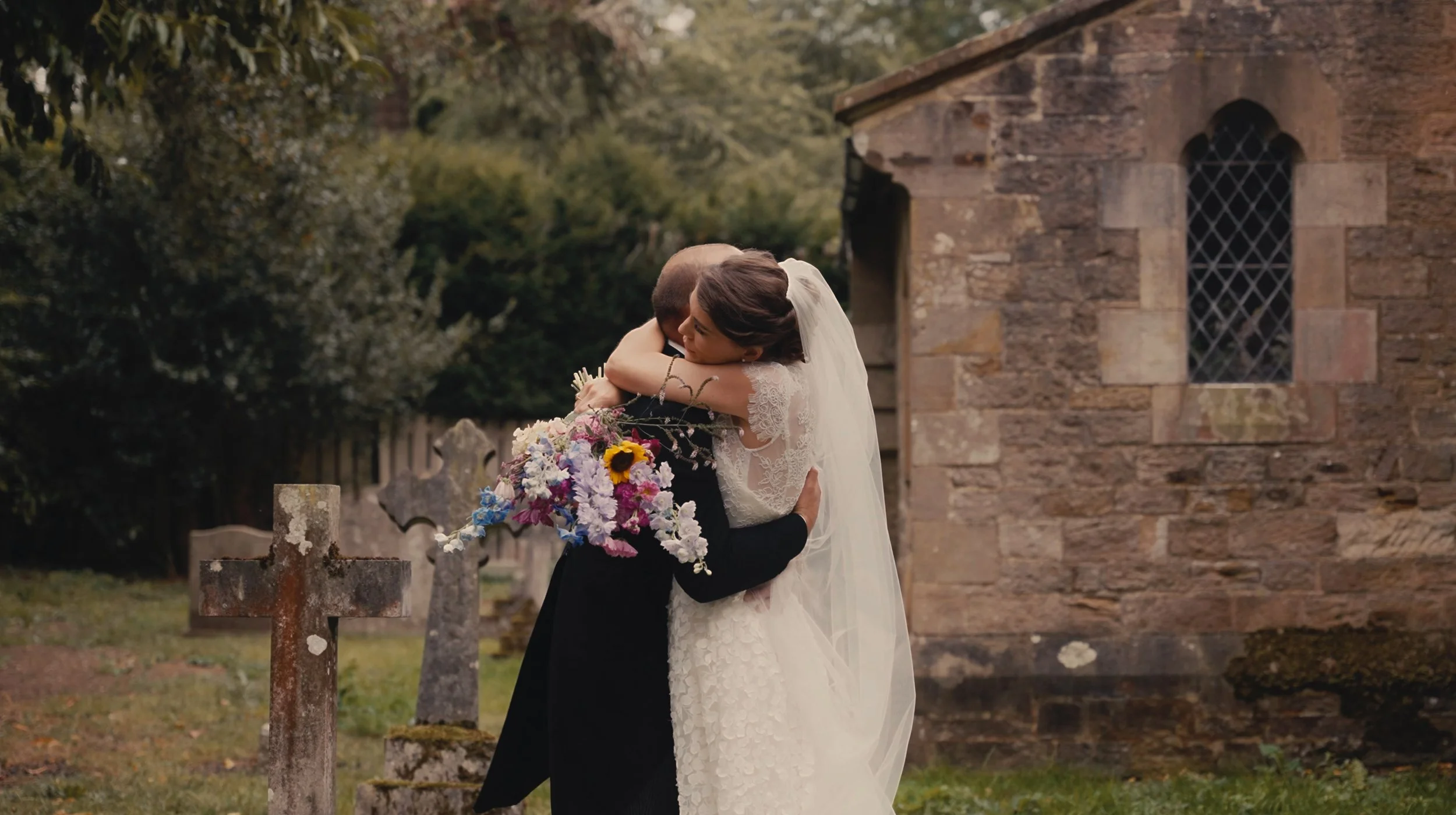 Bride and groom hugging outside church