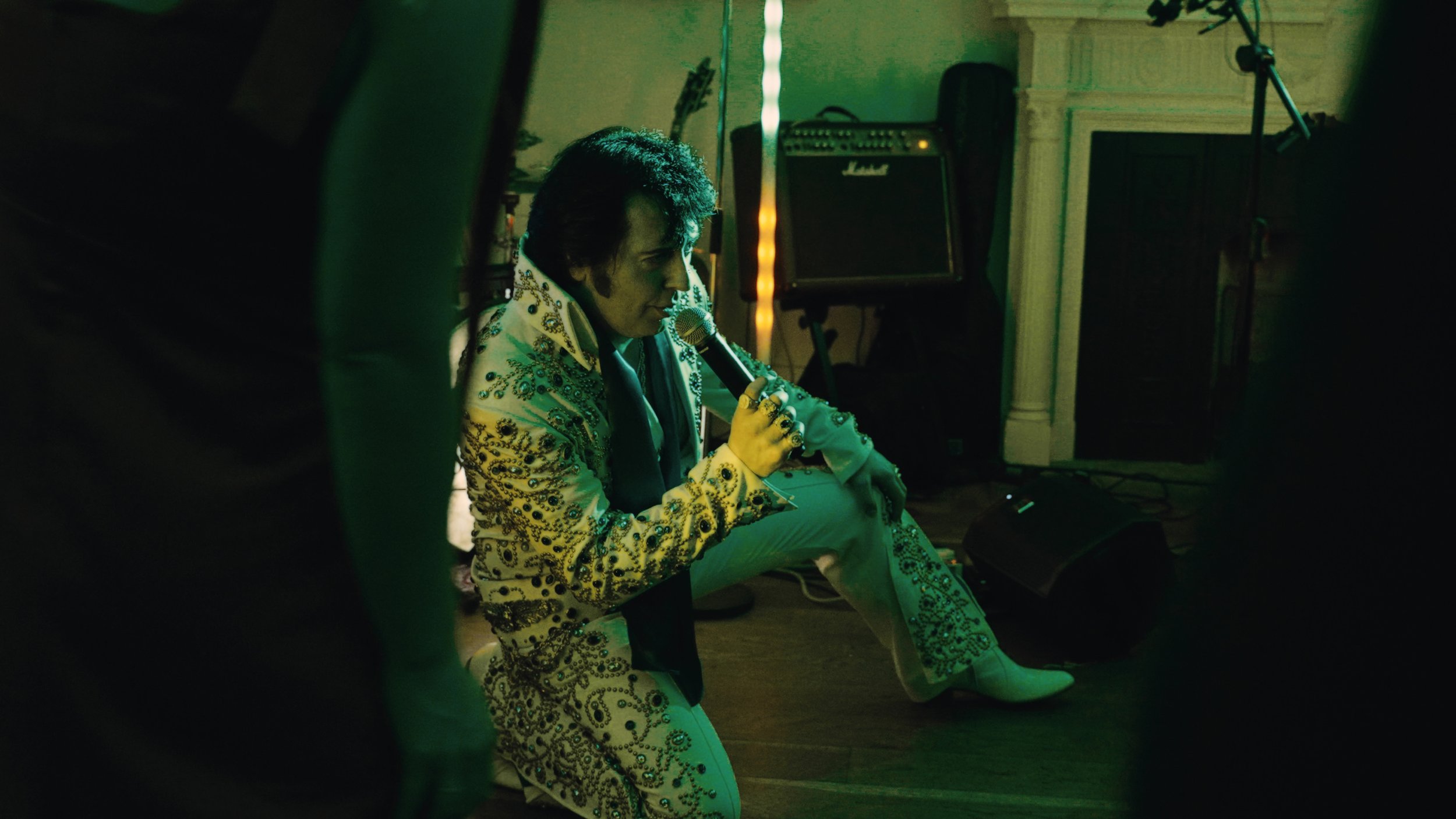 Elvis on the floor singing.