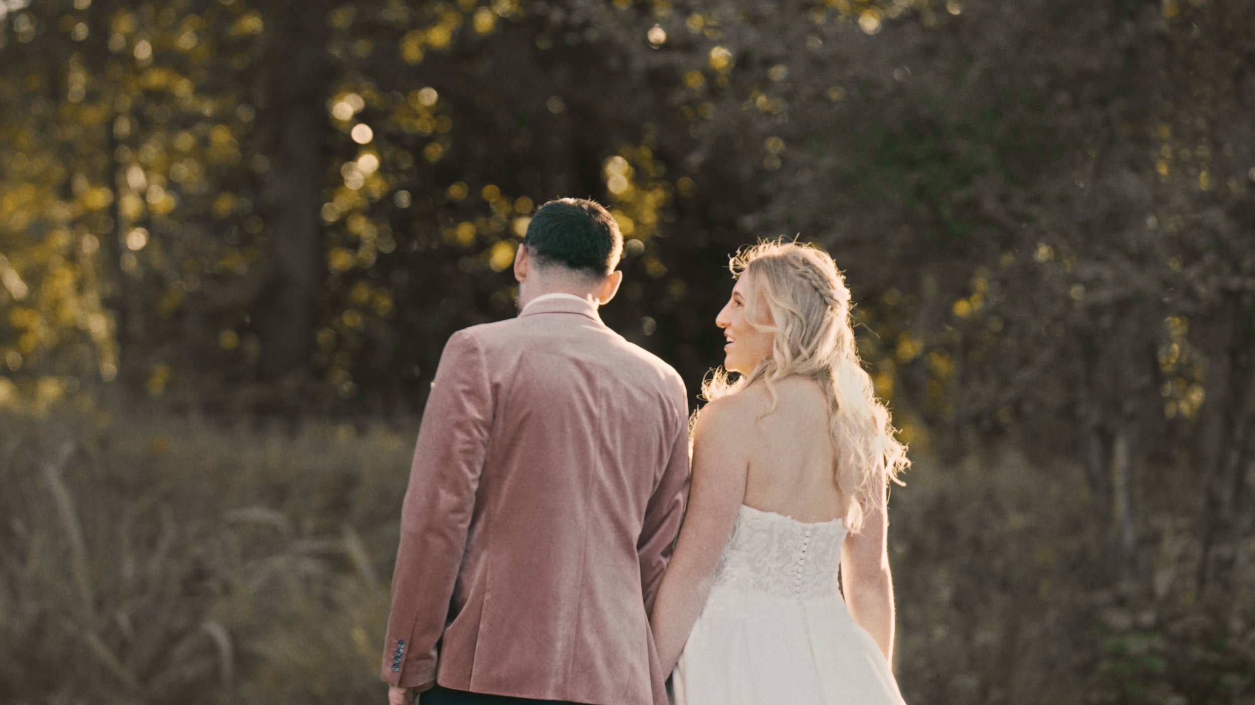 Bride and Groom walking at sunset.