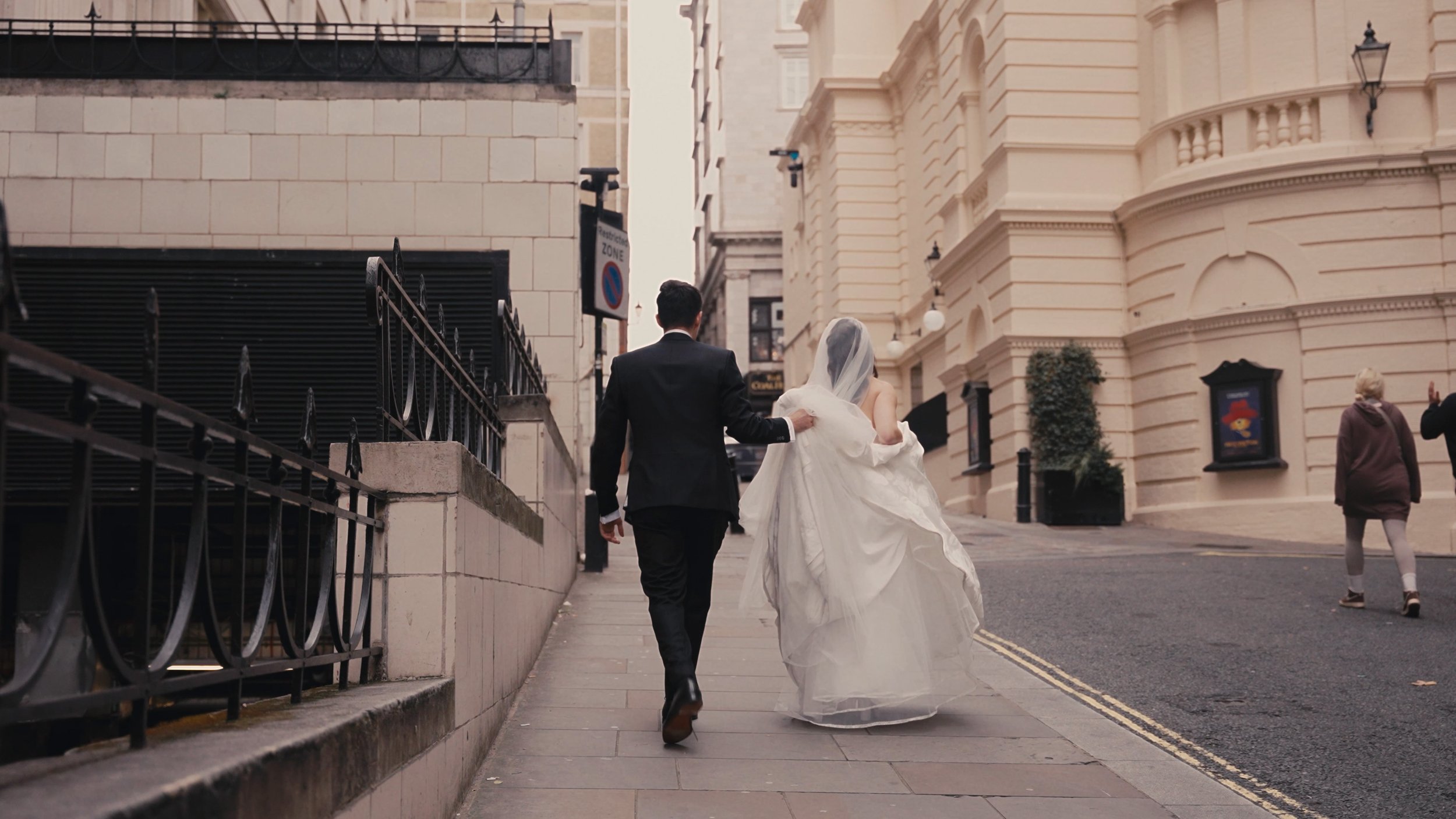Bride and groom walking on a London street