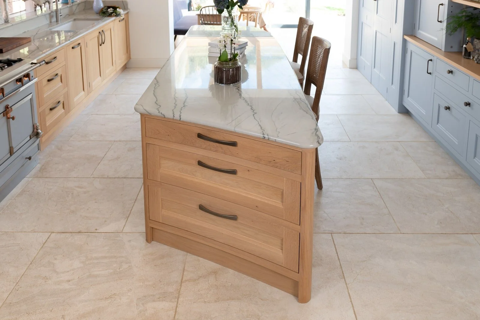 Contemporary handmade Surrey kitchen with Domus quartzite worktops and curved island.