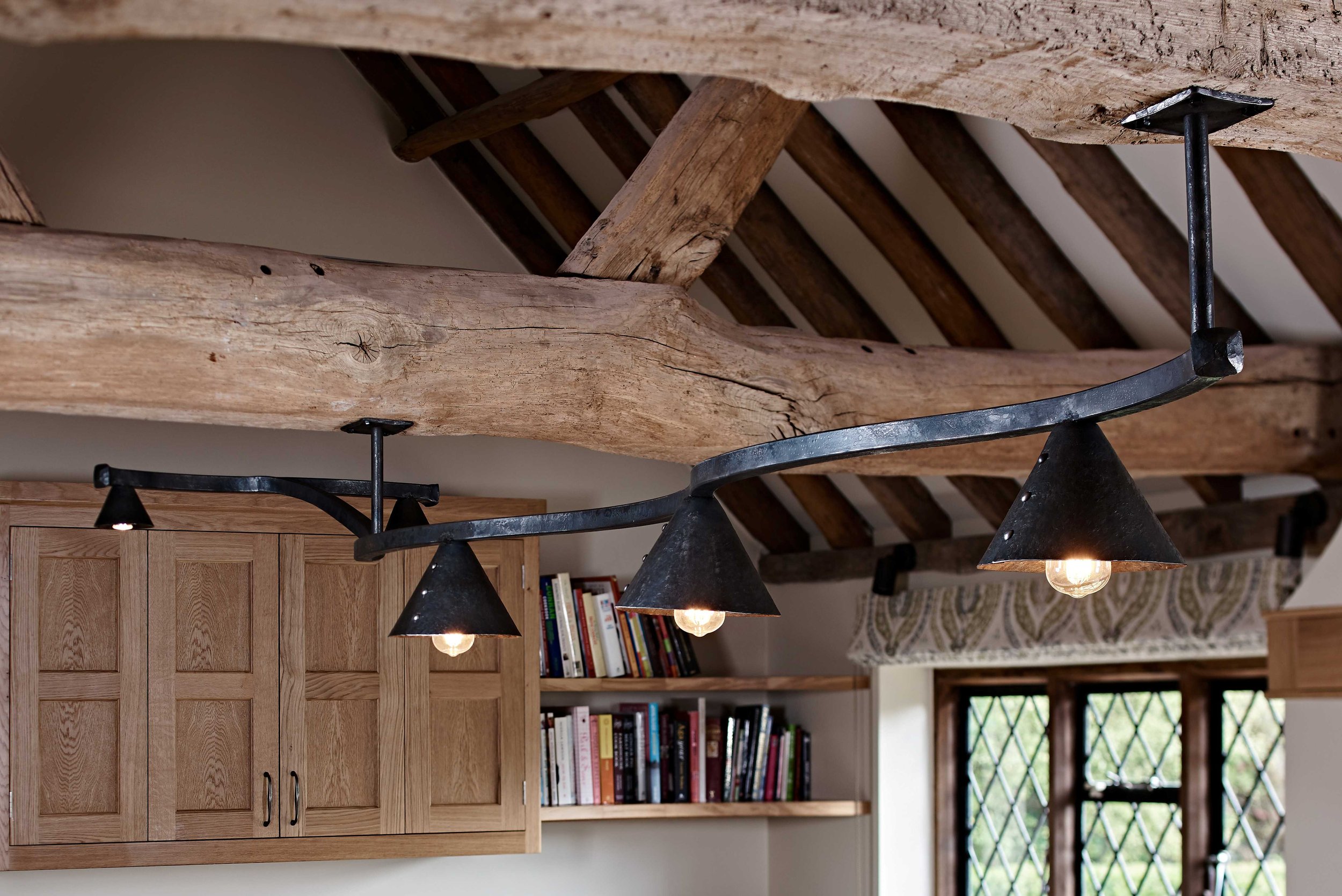 Bespoke forged iron handmade lighting designed for Surrey interiors project.