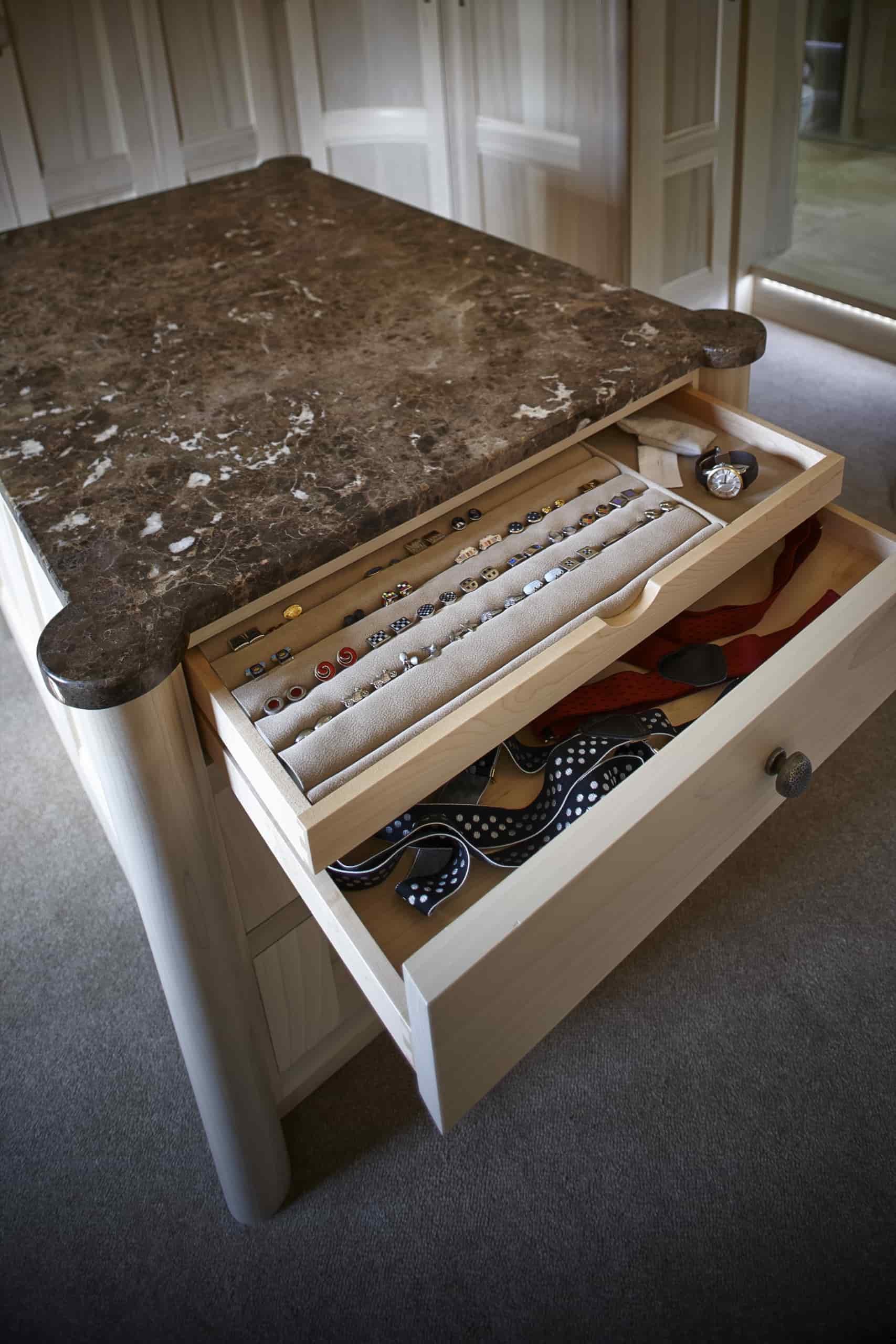 Handmade bespoke bedroom island with storage for watches, cufflinks and knitwear in Surrey home.