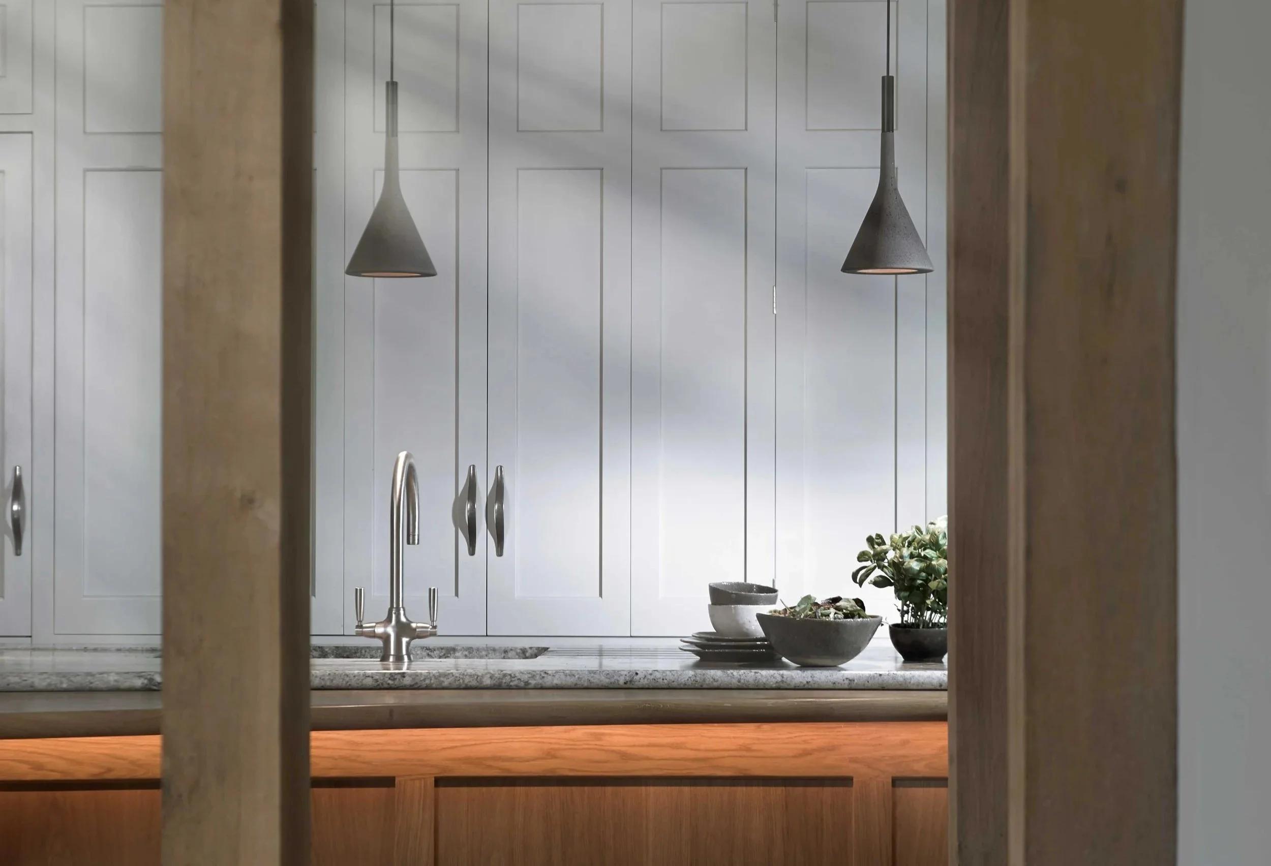 Bespoke painted cabinetry with natural timber in period Surrey kitchen