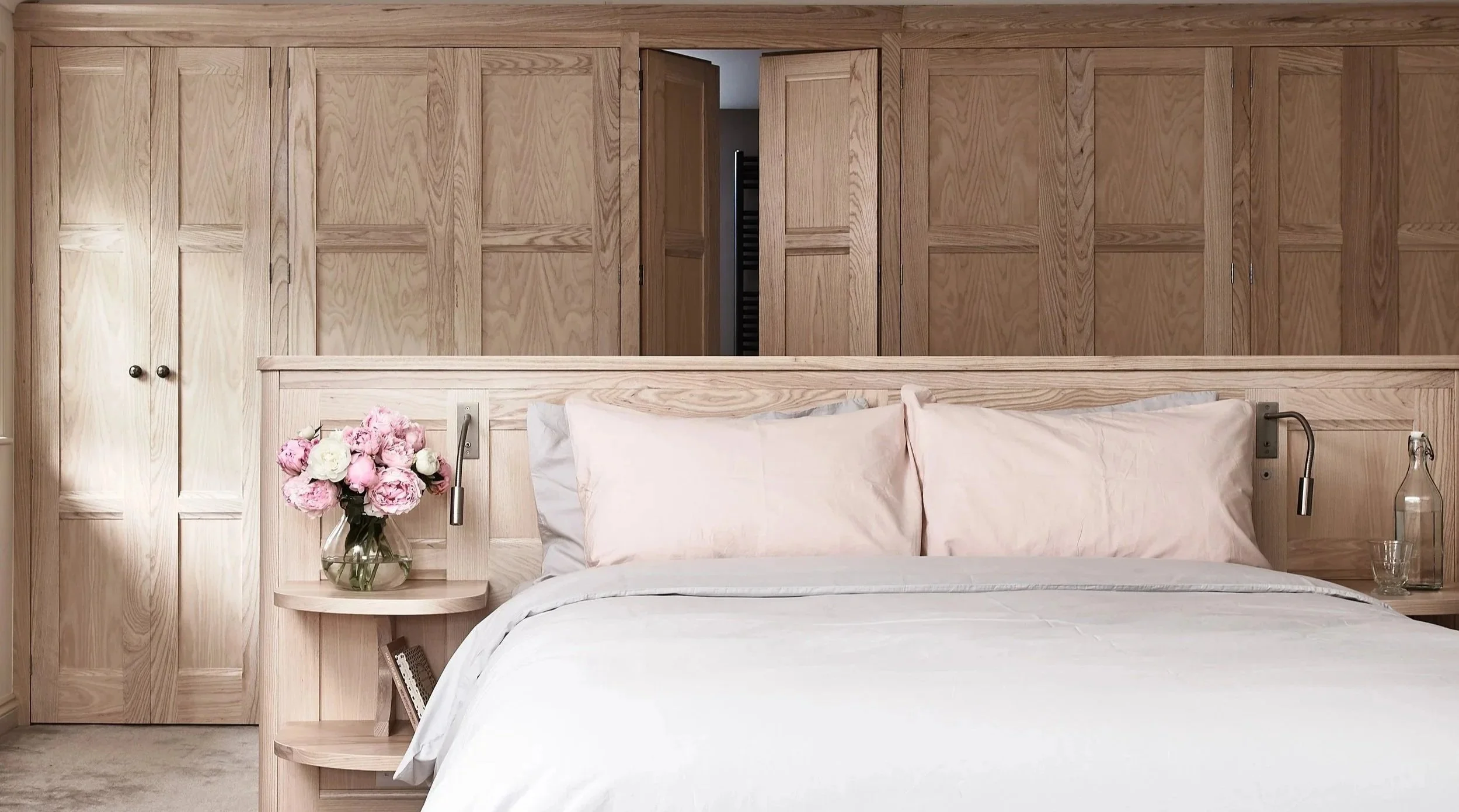 Breakthrough doors creating symmetrical axis between bedroom and ensuite, Surrey